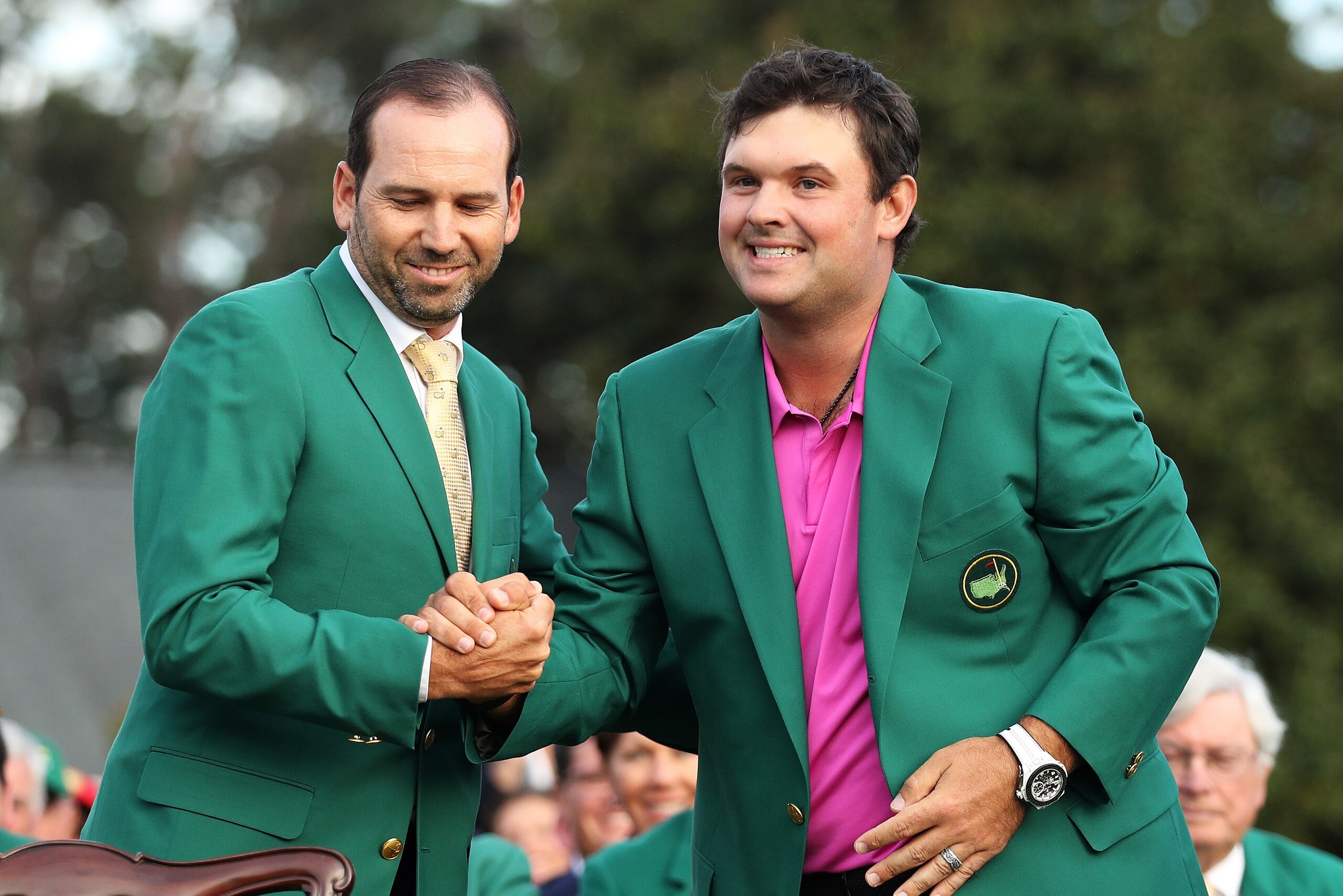 AUGUSTA, GA - APRIL 08:  Patrick Reed (R) of the United States is congratulated by Sergio Garcia (L) of Spain after being presented the green jacket after winning the 2018 Masters Tournament at Augusta National Golf Club on April 8, 2018 in Augusta, Georg