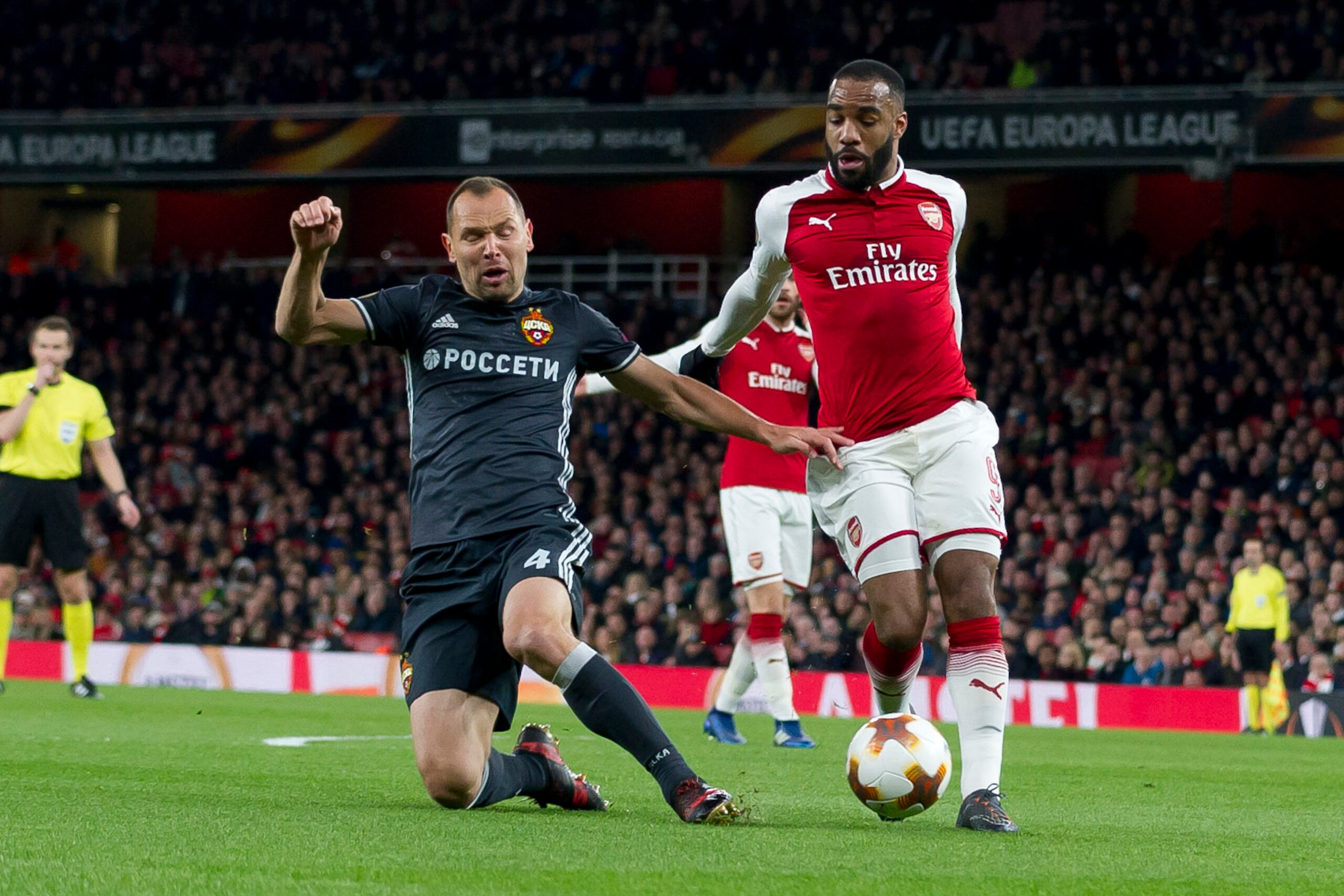 LONDON, ENGLAND - APRIL 05: Sergey Ignashevich of CSKA Moskva and Alexandre Lacazette of Arsenal battle for the ball during the UEFA UEFA Europa League Quarter-Final first leg match between Arsenal FC and CSKA Moskva at Emirates Stadium on April 5, 2018 i