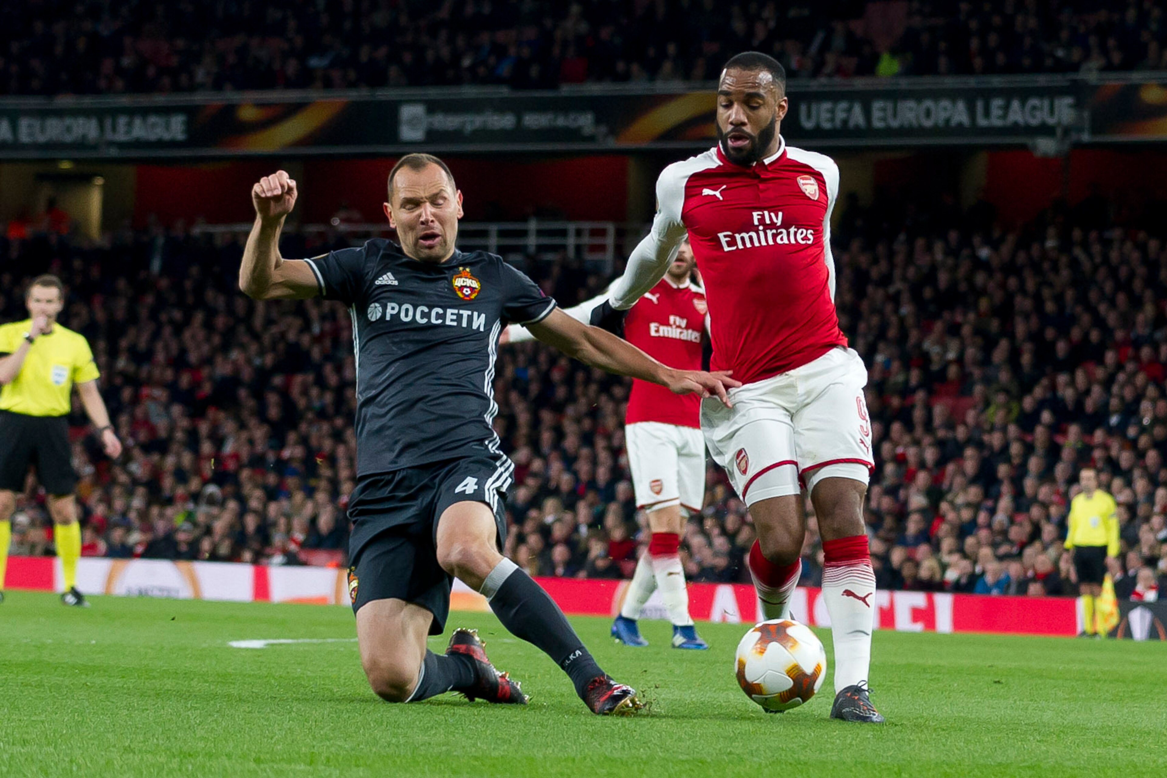 LONDON, ENGLAND - APRIL 05: Sergey Ignashevich of CSKA Moskva and Alexandre Lacazette of Arsenal battle for the ball during the UEFA UEFA Europa League Quarter-Final first leg match between Arsenal FC and CSKA Moskva at Emirates Stadium on April 5, 2018 i