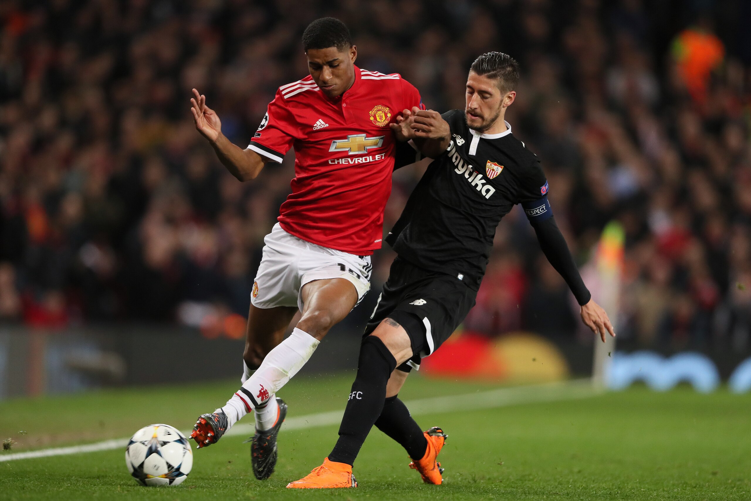 MANCHESTER, ENGLAND - MARCH 13: Marcus Rashford of Manchester United and Sergio Escudero of Sevilla during the UEFA Champions League Round of 16 Second Leg match between Manchester United and Sevilla FC at Old Trafford on March 13, 2018 in Manchester, Uni