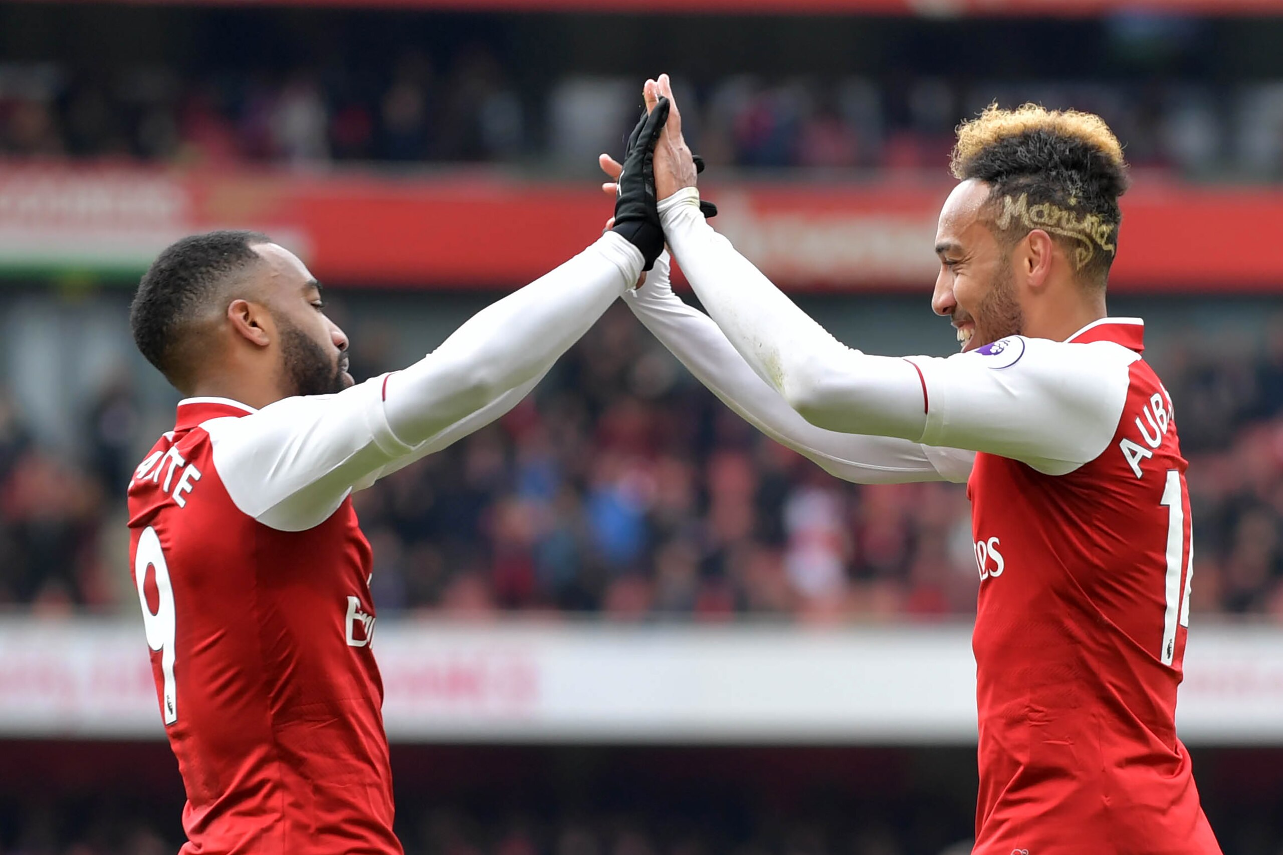 Arsenal's Gabonese striker Pierre-Emerick Aubameyang (R) celebrates scoring the team's second goal with Arsenal's French striker Alexandre Lacazette during the English Premier League football match between Arsenal and Stoke City at the Emirates Stadium in