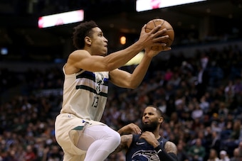 MILWAUKEE, WI - APRIL 09: Malcolm Brogdon #13 of the Milwaukee Bucks attempts a shot past D.J. Augustin #14 of the Orlando Magic in the second quarter at the Bradley Center on April 9, 2018 in Milwaukee, Wisconsin. NOTE TO USER: User expressly acknowledg MILWAUKEE, WI - APRIL 09: Malcolm Brogdon #13 of the Milwaukee Bucks attempts a shot past D.J. Augustin #14 of the Orlando Magic in the second quarter at the Bradley Center on April 9, 2018 in Milwaukee, Wisconsin. NOTE TO USER: User expressly acknowledg
