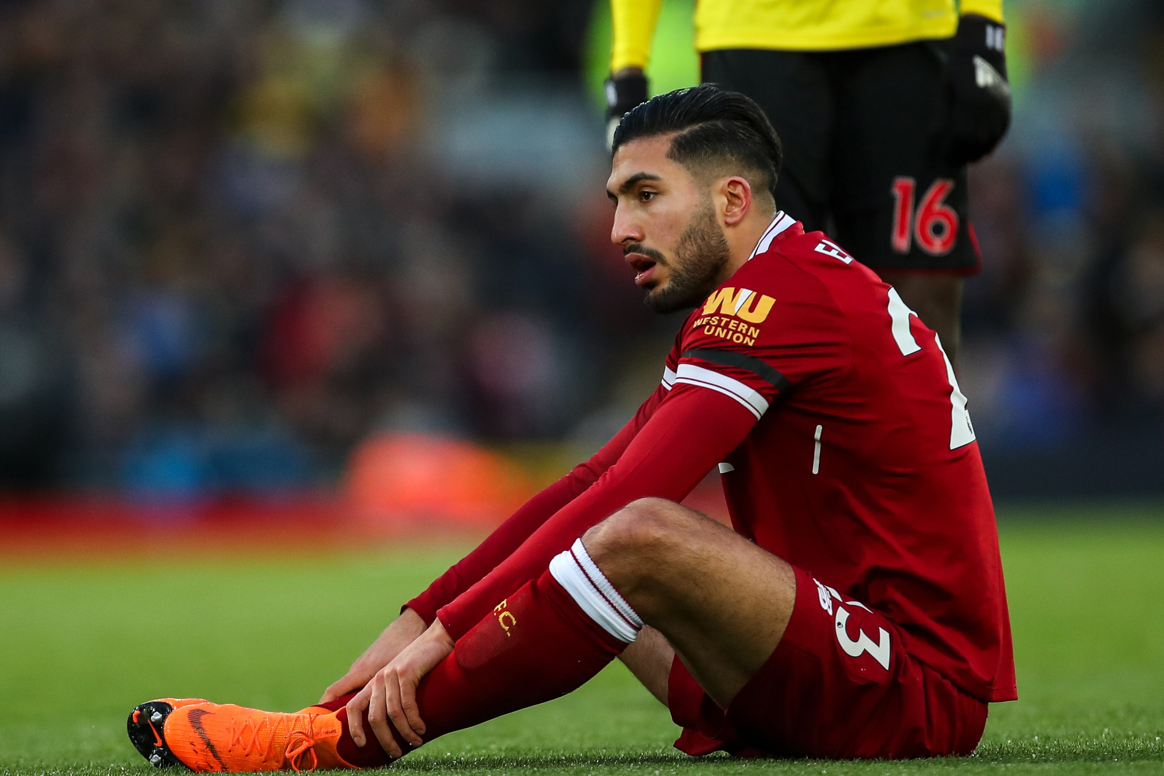 LIVERPOOL, ENGLAND - MARCH 17: Emre Can of Liverpool picks up an injury which results in him being taken off during the Premier League match between Liverpool and Watford at Anfield on March 17, 2018 in Liverpool, England. (Photo by Robbie Jay Barratt - A