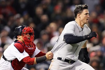 BOSTON, MA - APRIL 11: Christian Vazquez #7 of the Boston Red Sox tries to hold back Tyler Austin #26 of the New York Yankees as he storms the pitchers mound after being stuck by a pitch thrown by Joe Kelly #56 during the seventh inning at Fenway Park on 