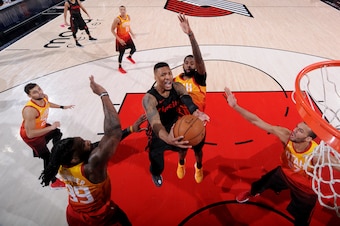 PORTLAND, OR - APRIL 11: Damian Lillard #0 of the Portland Trail Blazers goes to the basket against the Utah Jazz on April 11, 2018 at the Moda Center in Portland, Oregon. NOTE TO USER: User expressly acknowledges and agrees that, by downloading and or us