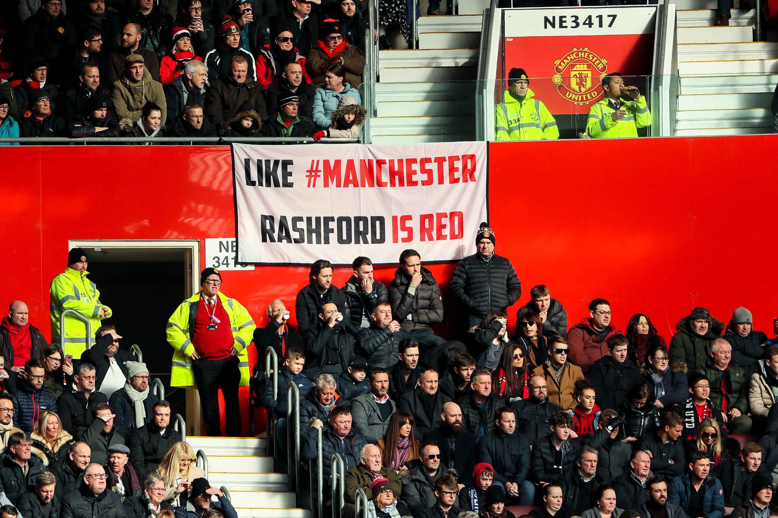 MANCHESTER, ENGLAND - FEBRUARY 25: Fans of Manchester United look on as banner which reads Like Manchester Rashford is Red is seen during the Premier League match between Manchester United and Chelsea at Old Trafford on February 25, 2018 in Manchester, En