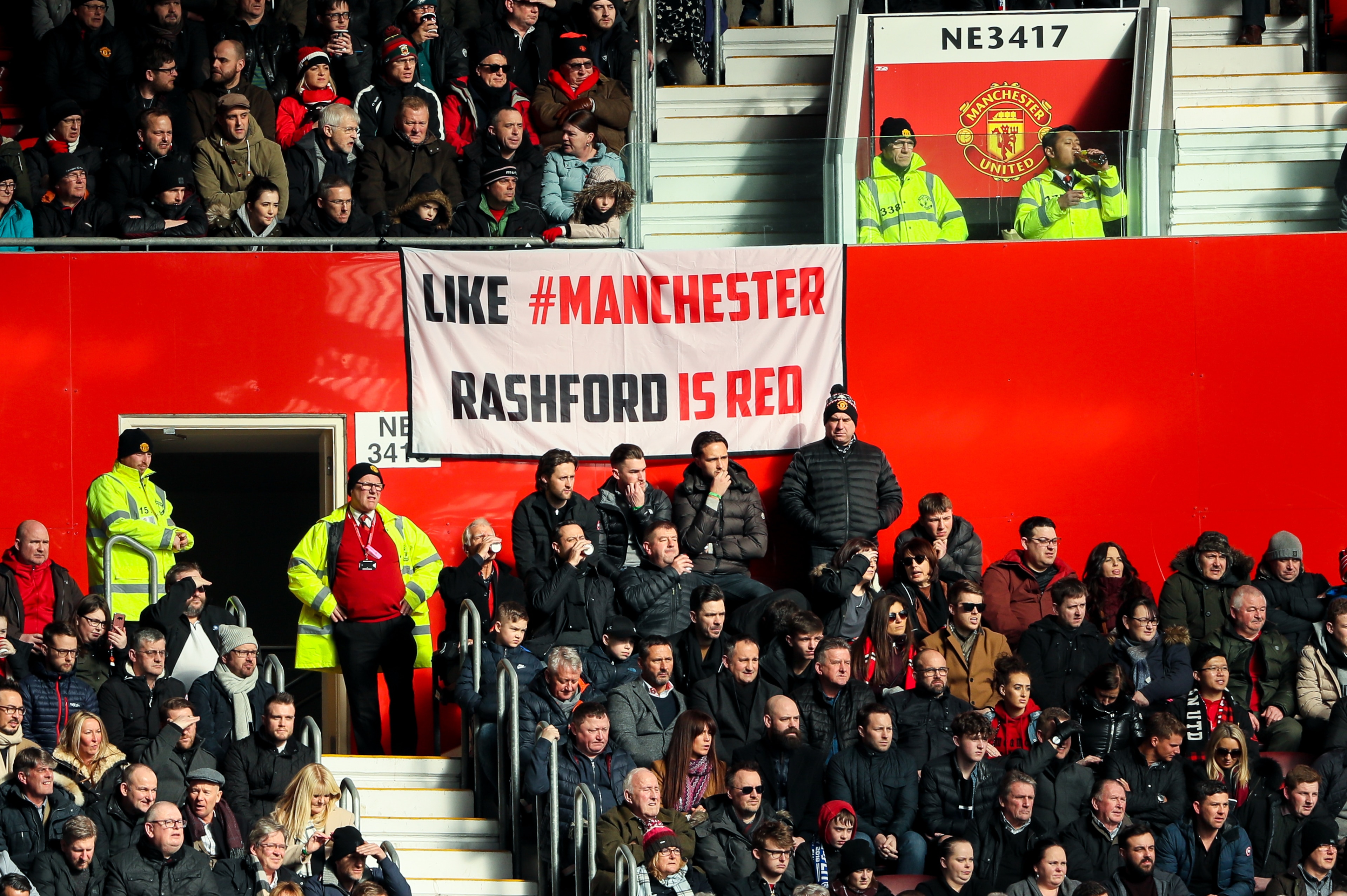 MANCHESTER, ENGLAND - FEBRUARY 25: Fans of Manchester United look on as banner which reads Like Manchester Rashford is Red is seen during the Premier League match between Manchester United and Chelsea at Old Trafford on February 25, 2018 in Manchester, En