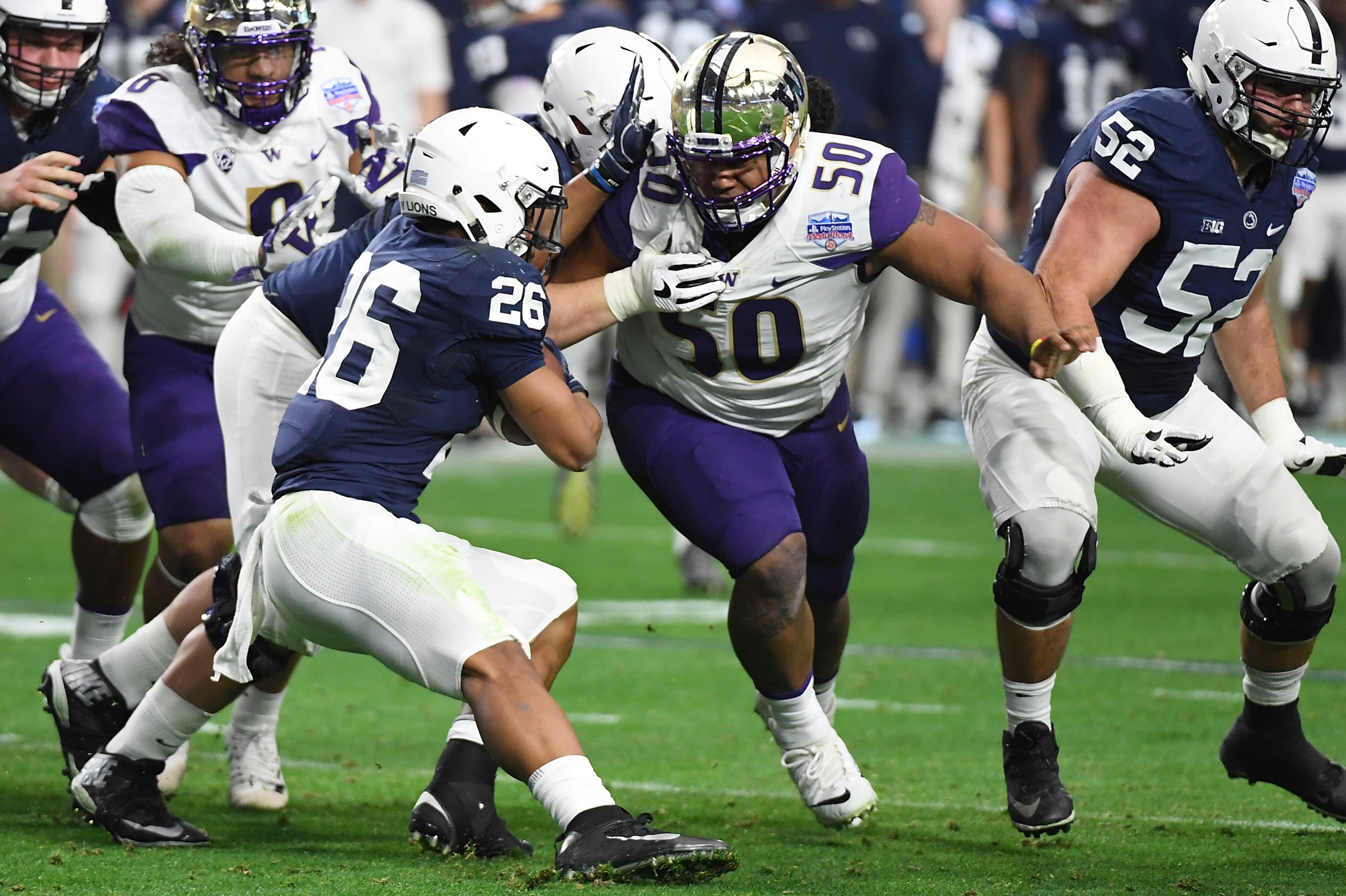 GLENDALE, AZ - DECEMBER 30:  Vita Vea #50 of the Washington Huskies attempts to tackle Saquon Barkley #26 of the Penn State Nittany Lions during the Playstation Fiesta Bowl at University of Phoenix Stadium on December 30, 2017 in Glendale, Arizona.  (Phot