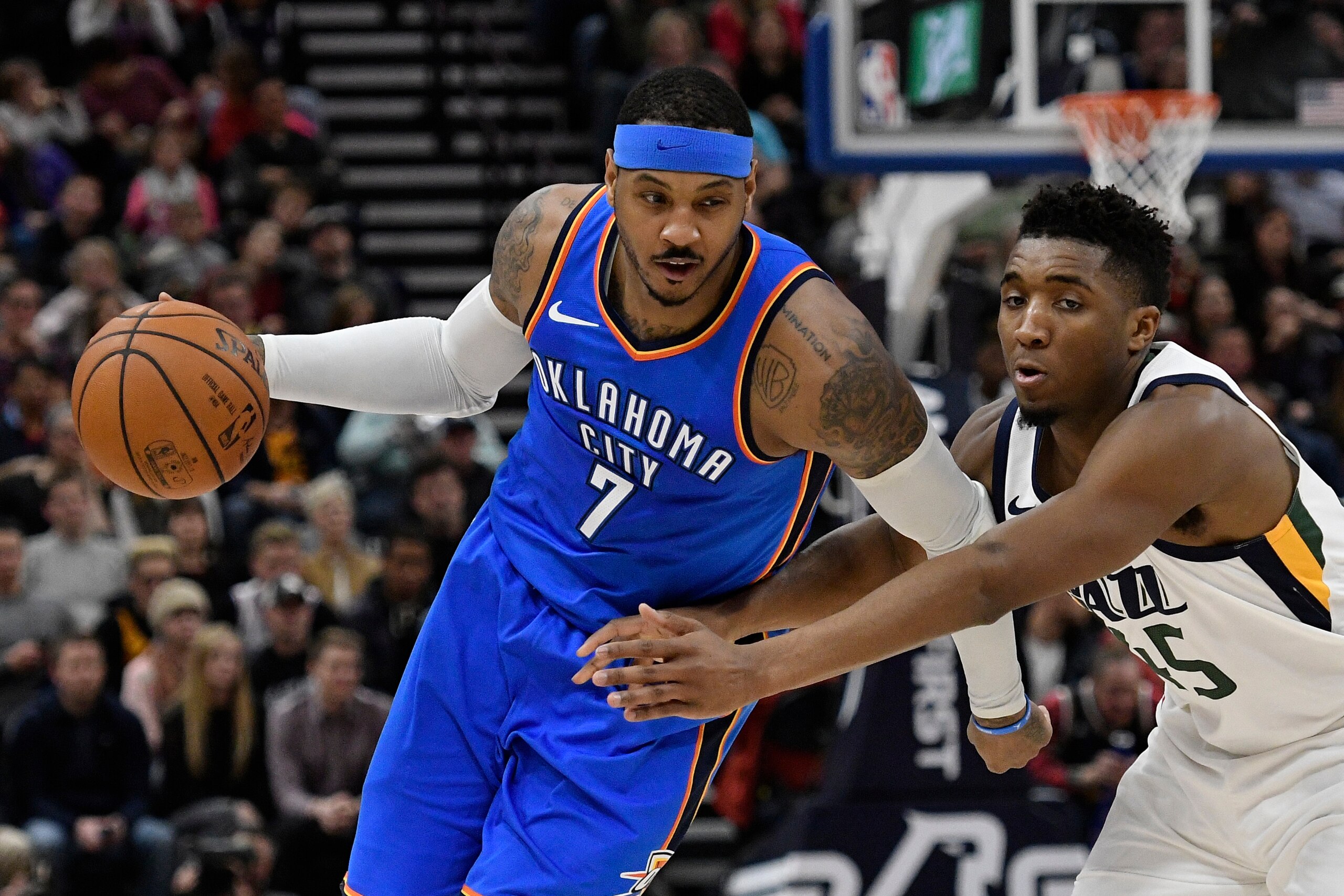 SALT LAKE CITY, UT - DECEMBER 23: Carmelo Anthony #7 of the Oklahoma City Thunder drives past Donovan Mitchell #45 of the Utah Jazz during their game at Vivint Smart Home Arena on December 23, 2017 in Salt Lake City, Utah. NOTE TO USER: User expressly ack