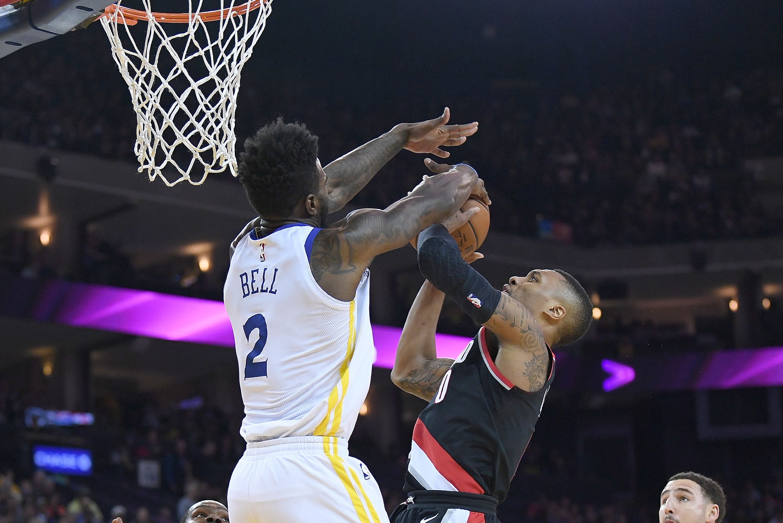 OAKLAND, CA - DECEMBER 11:  Damian Lillard #0 of the Portland Trail Blazers goes up and has his shot blocked by Jordan Bell #2 of the Golden State Warriors during an NBA basketball game at ORACLE Arena on December 11, 2017 in Oakland, California. NOTE TO 