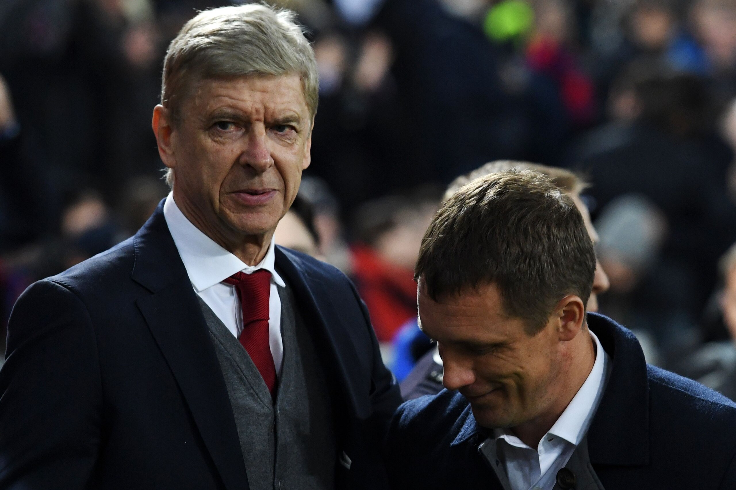 Arsenal's French manager Arsene Wenger (L) salutes CSKA Moscow's Belarusian manager Viktor Goncharenko before the UEFA Europa League quarter-final second leg football match between CSKA Moscow and Arsenal at the VEB Arena stadium in Moscow on April 12, 20