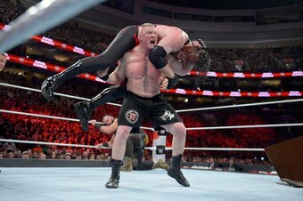 Brock Lesnar hits an F-5 on Kane.
