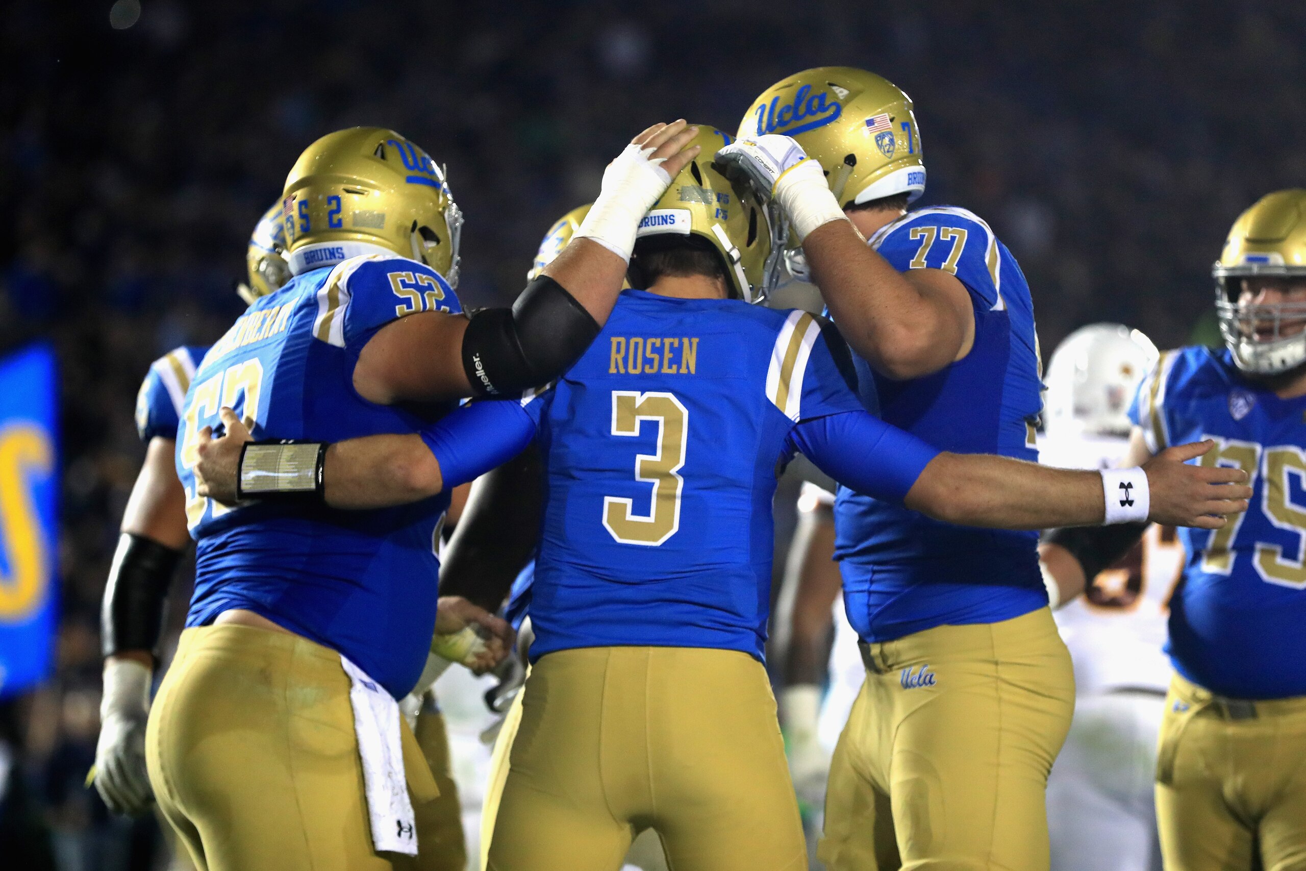 PASADENA, CA - NOVEMBER 11:  Kolton Miller #77 and Scott Quessenberry #52 congratulate Josh Rosen #3 of the UCLA Bruins after his touchdown during the first half of a game against the Arizona State Sun Devils  at the Rose Bowl on November 11, 2017 in Pasa