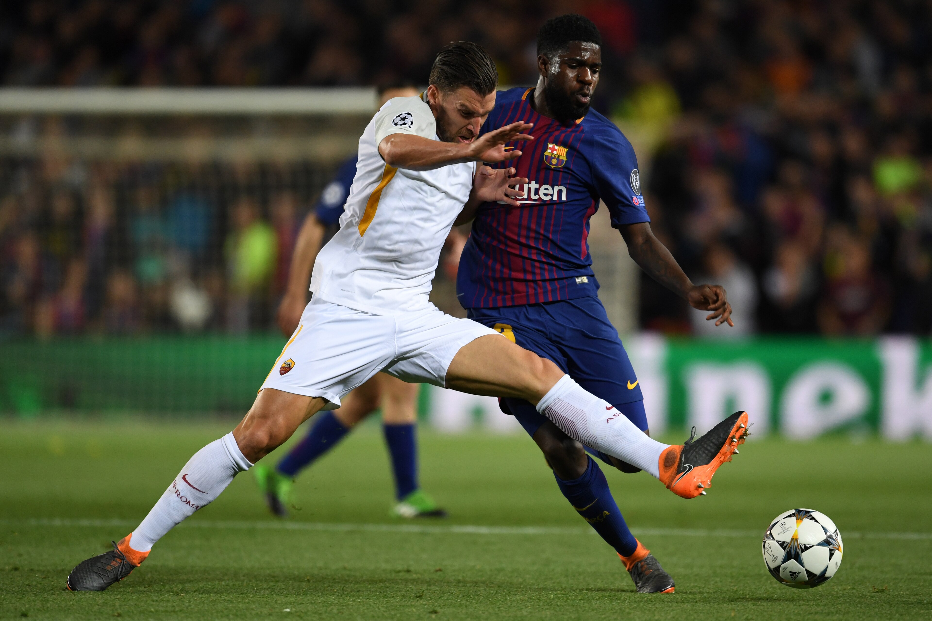 BARCELONA, SPAIN - APRIL 04: Kostas Manolas of Roma and Samuel Umtiti of Barcelona compete for the ball during the UEFA Champions League Quarter Final First Leg between FC Barcelona adn AS Roma at Camp Nou on April 4, 2018 in Barcelona, Spain. (Photo by E