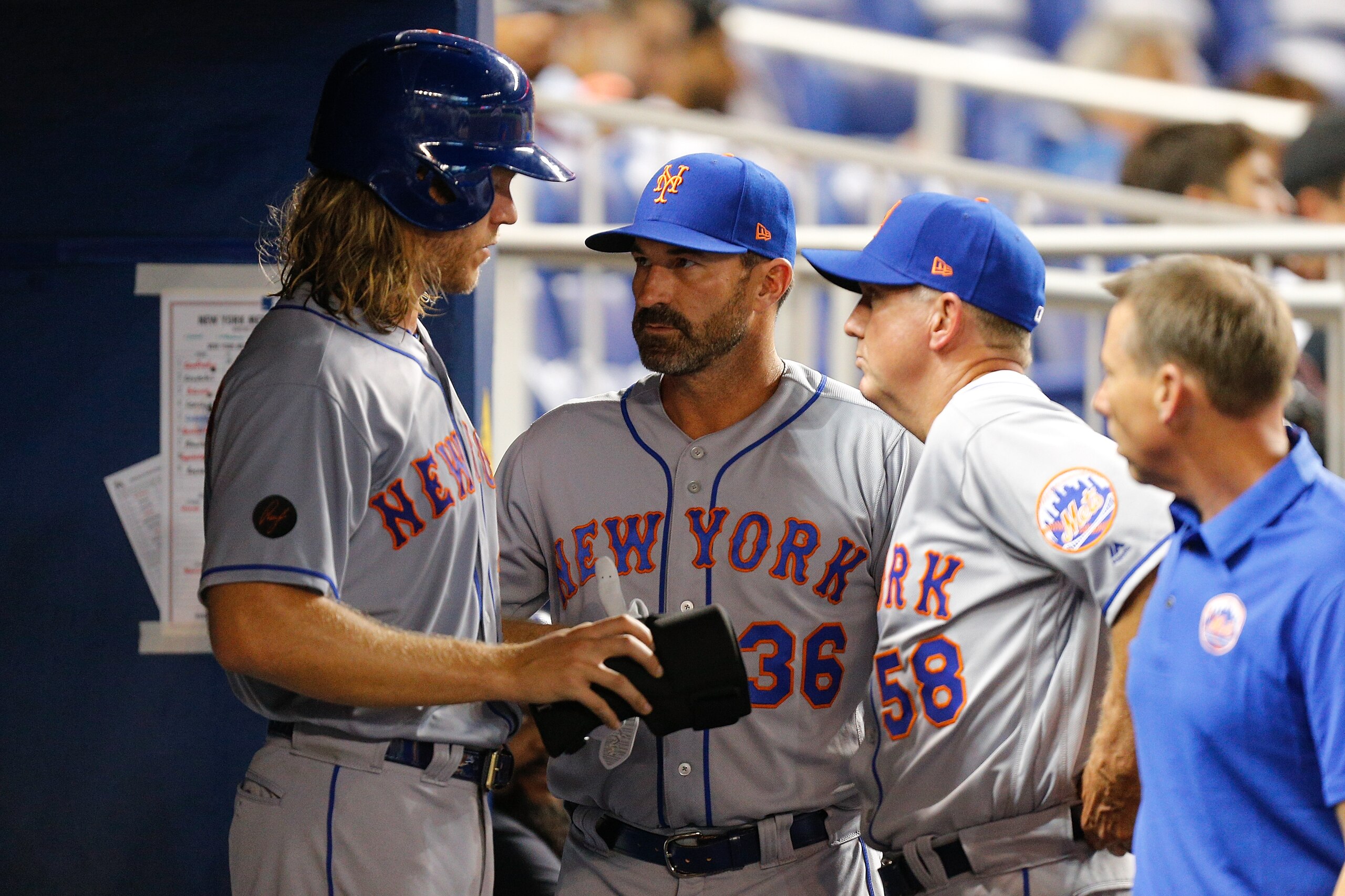 MIAMI, FL - APRIL 09:  Noah Syndergaard #34 of the New York Mets talks with manager Mickey Callaway #36 and pitching coach Dave Eiland #58 against the Miami Marlins at Marlins Park on April 9, 2018 in Miami, Florida.  (Photo by Michael Reaves/Getty Images