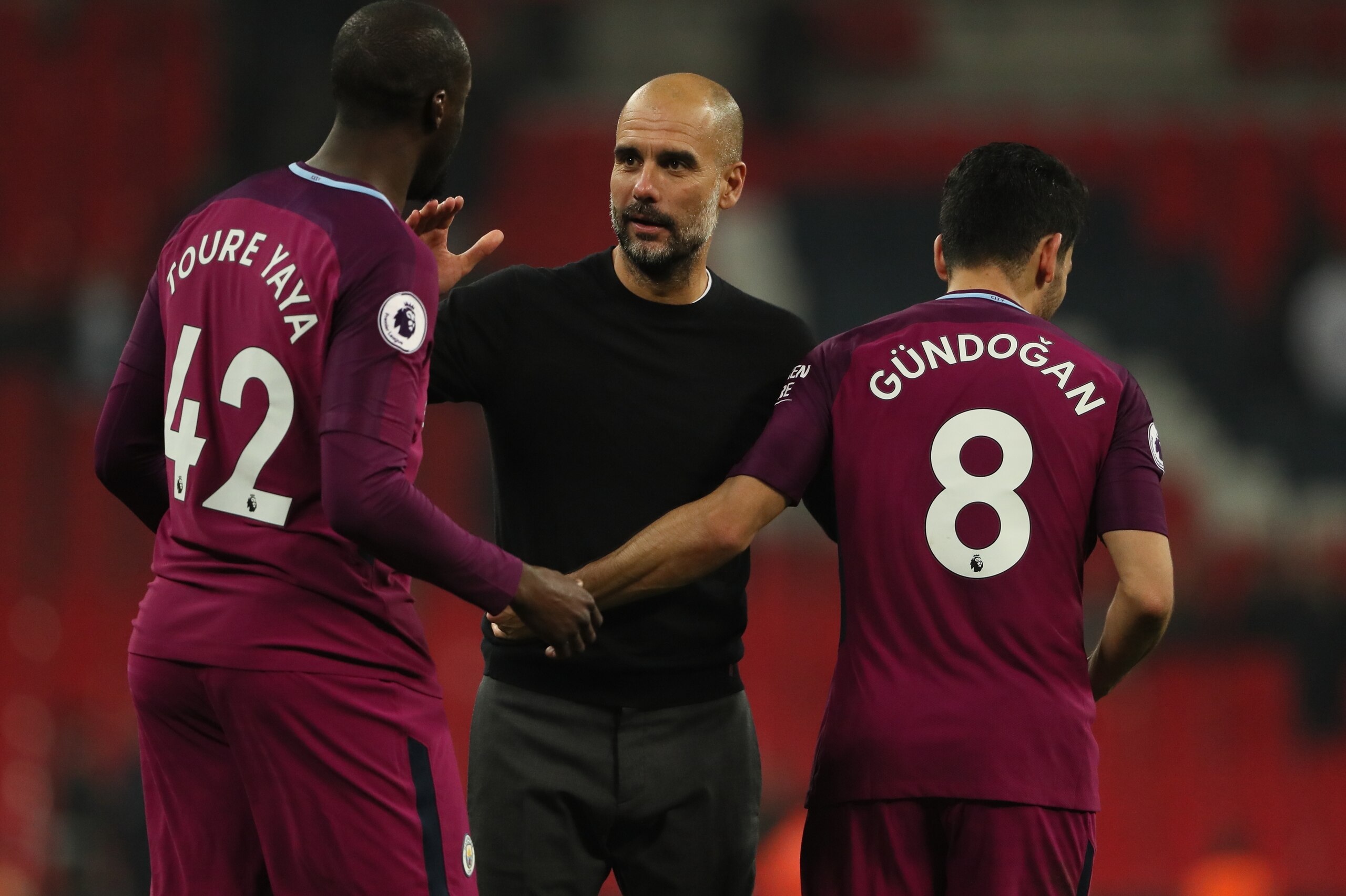 LONDON, ENGLAND - APRIL 14: Yaya Toure of Manchester City and Manchester City manager Pep Guardiola and Ilkay Gundogan of Manchester City during the Premier League match between Tottenham Hotspur and Manchester City at Wembley Stadium on April 14, 2018 in