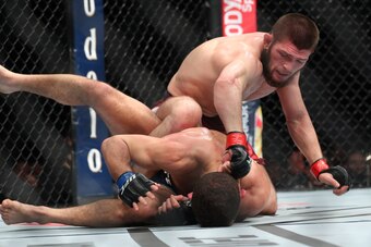 NEW YORK, NY - APRIL 07: Khabib Nurmagomedov (top) throws a punch at Al Iaquinta (bottom) during their UFC lightweight championship bout at UFC 223 at Barclays Center on April 7, 2018 in New York City. (Photo by Ed Mulholland/Getty Images)