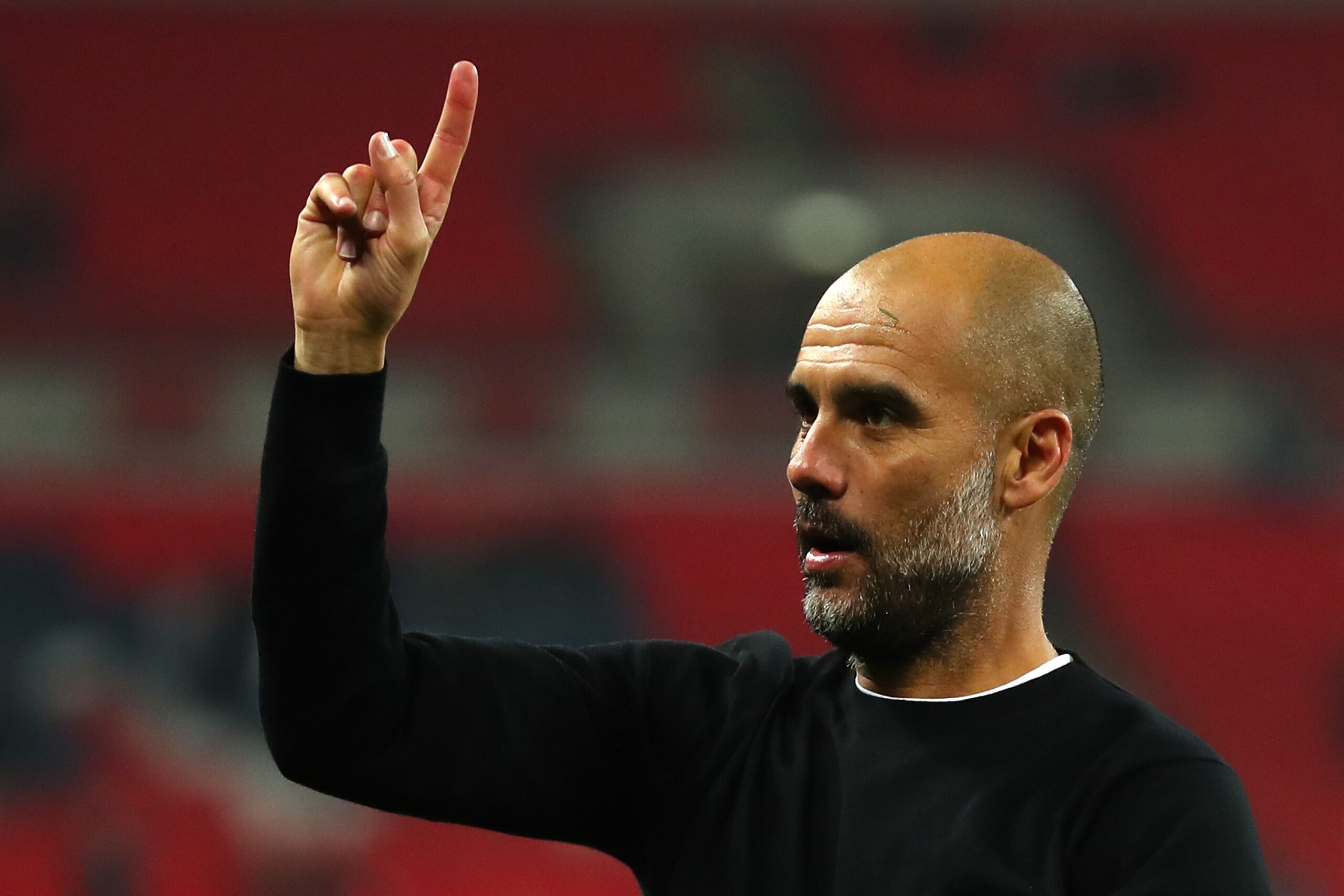 LONDON, ENGLAND - APRIL 14: Josep Guardiola, Manager of Manchester City raises one finger to indicate one more game after the Premier League match between Tottenham Hotspur and Manchester City at Wembley Stadium on April 14, 2018 in London, England.  (Pho
