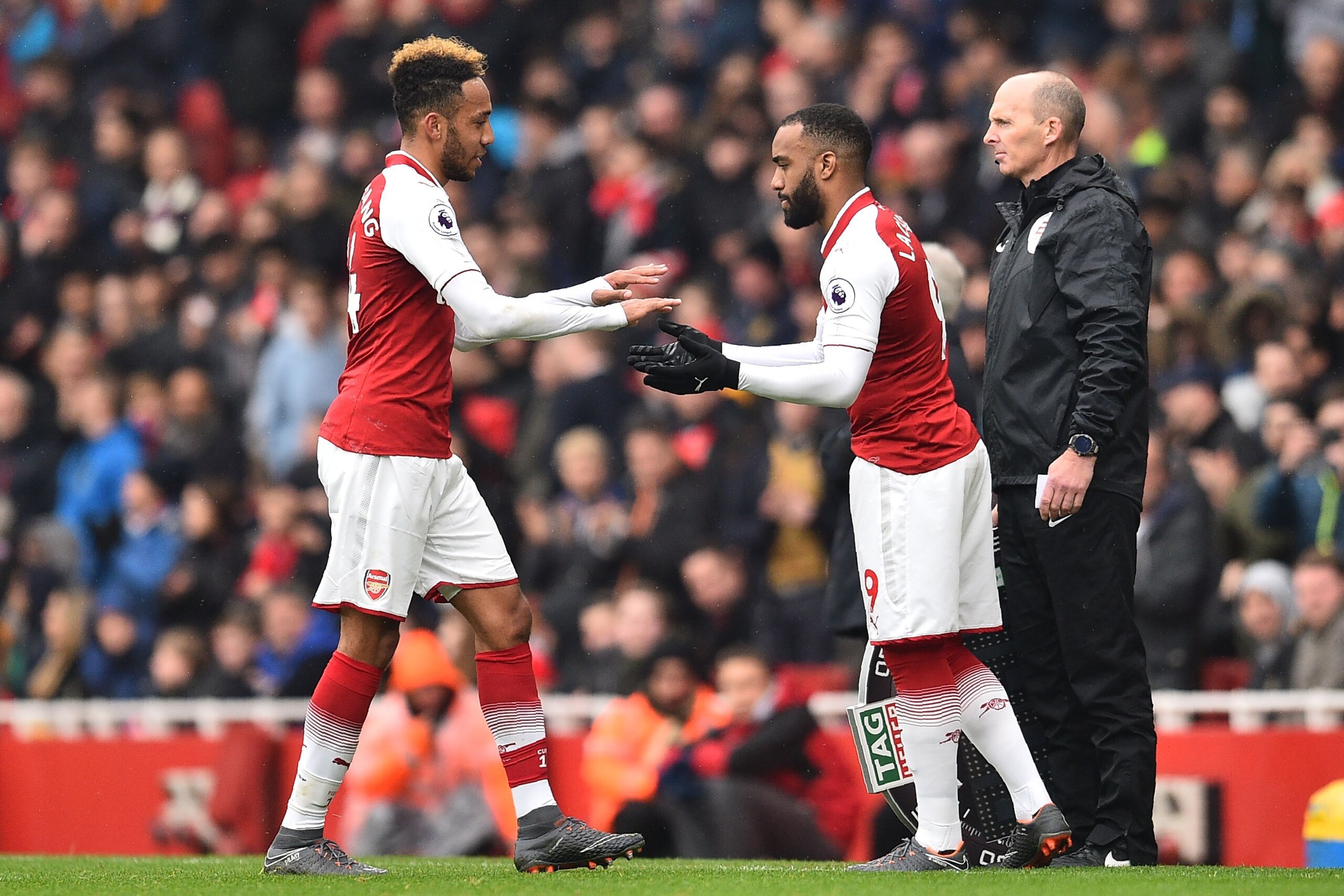 Arsenal's Gabonese striker Pierre-Emerick Aubameyang (L) is substituted by Arsenal's French striker Alexandre Lacazette during the English Premier League football match between Arsenal and Southampton at the Emirates Stadium in London on April 8, 2018.  /
