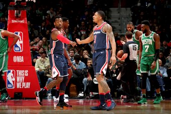 WASHINGTON, DC -  APRIL 10:  John Wall #2 and Bradley Beal #3 of the Washington Wizards high five during the game against the Boston Celtics on April 10, 2018 at Capital One Arena in Washington, DC. NOTE TO USER: User expressly acknowledges and agrees tha