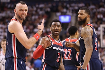 TORONTO, ON - APRIL 14: Marcin Gortat #13 of the Washington Wizards and John Wall #2 and Markieff Morris #5 discuss strategy against the Toronto Raptors during Game One of the first round of the 2018 NBA Playoffs at Air Canada Centre on April 14, 2018 in 
