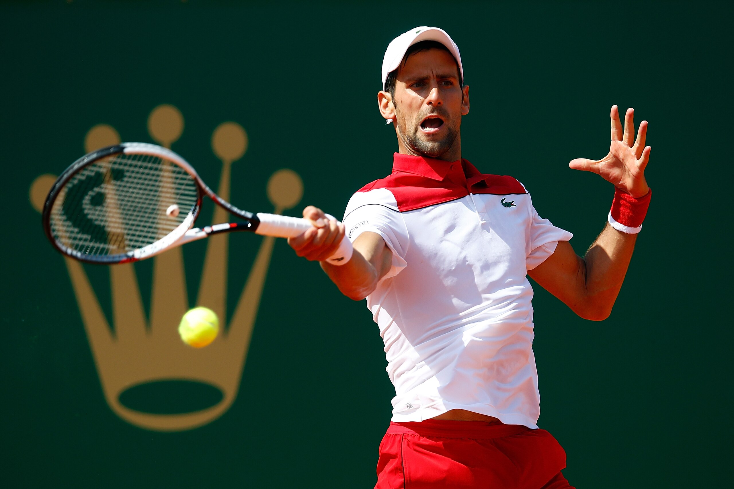 MONTE-CARLO, MONACO - APRIL 19: Noval Djokovic of Serbia plays a backhand against Dominic Thiem of Austria during his men's singles match on day five of the Rolex Monte-Carlo Masters at Monte-Carlo Sporting Club on April 19, 2018 in Monte-Carlo, Monaco. MONTE-CARLO, MONACO - APRIL 19: Noval Djokovic of Serbia plays a backhand against Dominic Thiem of Austria during his men's singles match on day five of the Rolex Monte-Carlo Masters at Monte-Carlo Sporting Club on April 19, 2018 in Monte-Carlo, Monaco.