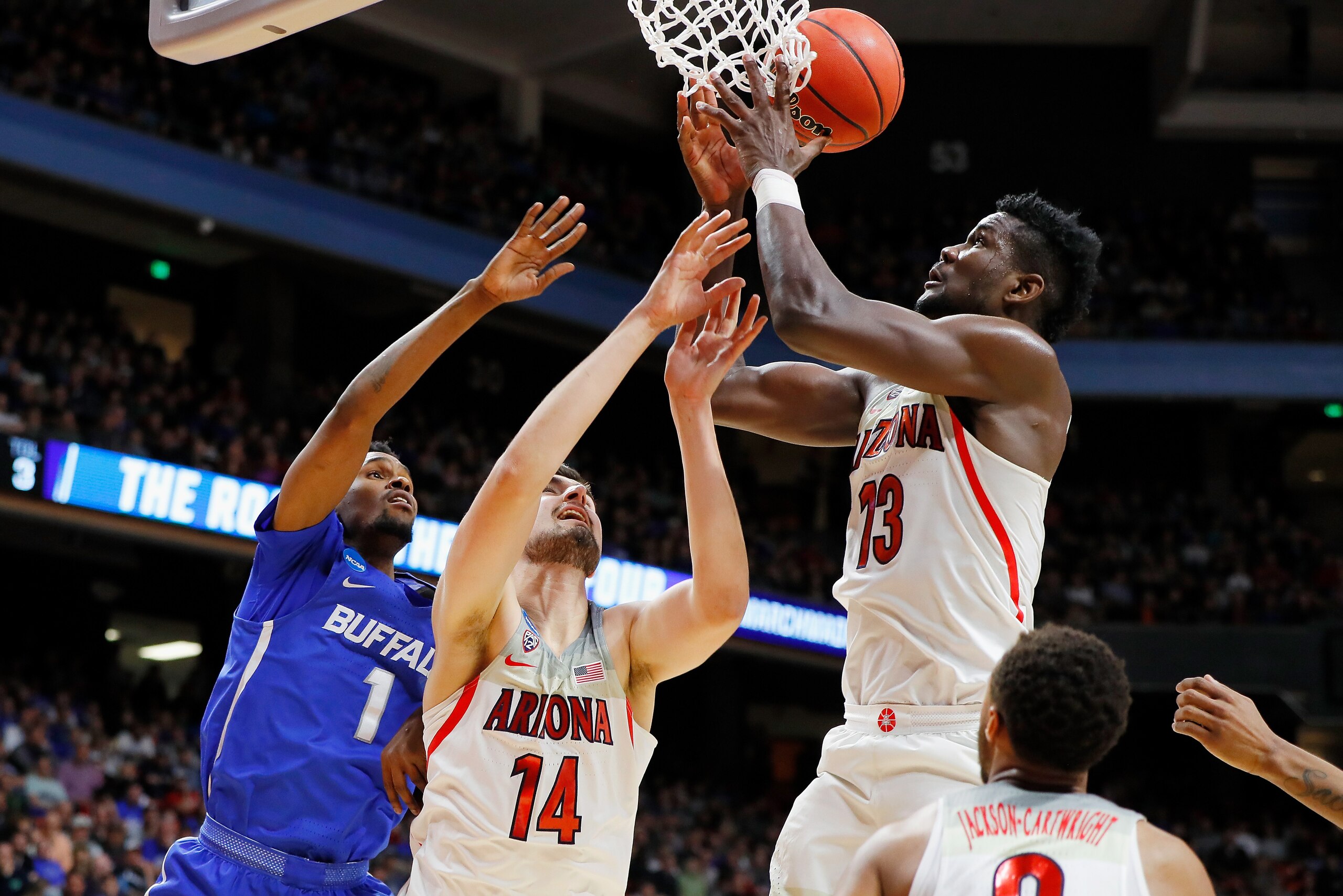 BOISE, ID - MARCH 15:  Deandre Ayton #13 and Dusan Ristic #14 of the Arizona Wildcats battle for the ball against Montell McRae #1 of the Buffalo Bulls in the first half during the first round of the 2018 NCAA Men's Basketball Tournament at Taco Bell Aren