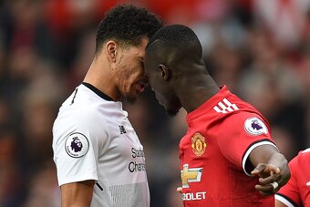 TOPSHOT - Manchester United's Ivorian defender Eric Bailly (R) confronts Liverpool's English striker Dominic Solanke (L) during the English Premier League football match between Manchester United and Liverpool at Old Trafford in Manchester, north west Eng
