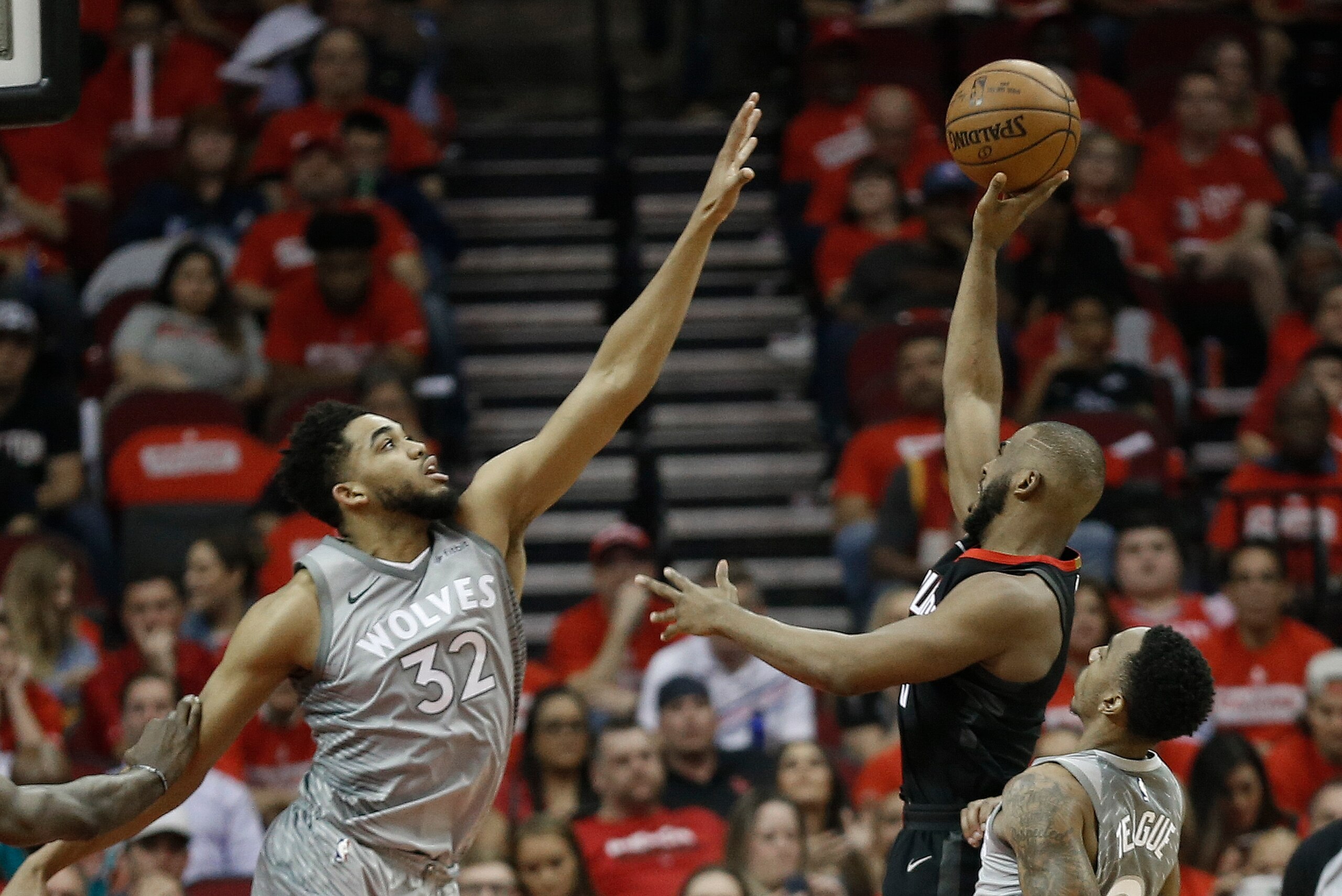 HOUSTON, TX - APRIL 18: Chris Paul #3 of the Houston Rockets shoots over Karl-Anthony Towns #32 of the Minnesota Timberwolves in the third quarter during Game Two of the first round of the Western Conference playoffs at Toyota Center on April 18, 2018 in HOUSTON, TX - APRIL 18: Chris Paul #3 of the Houston Rockets shoots over Karl-Anthony Towns #32 of the Minnesota Timberwolves in the third quarter during Game Two of the first round of the Western Conference playoffs at Toyota Center on April 18, 2018 in