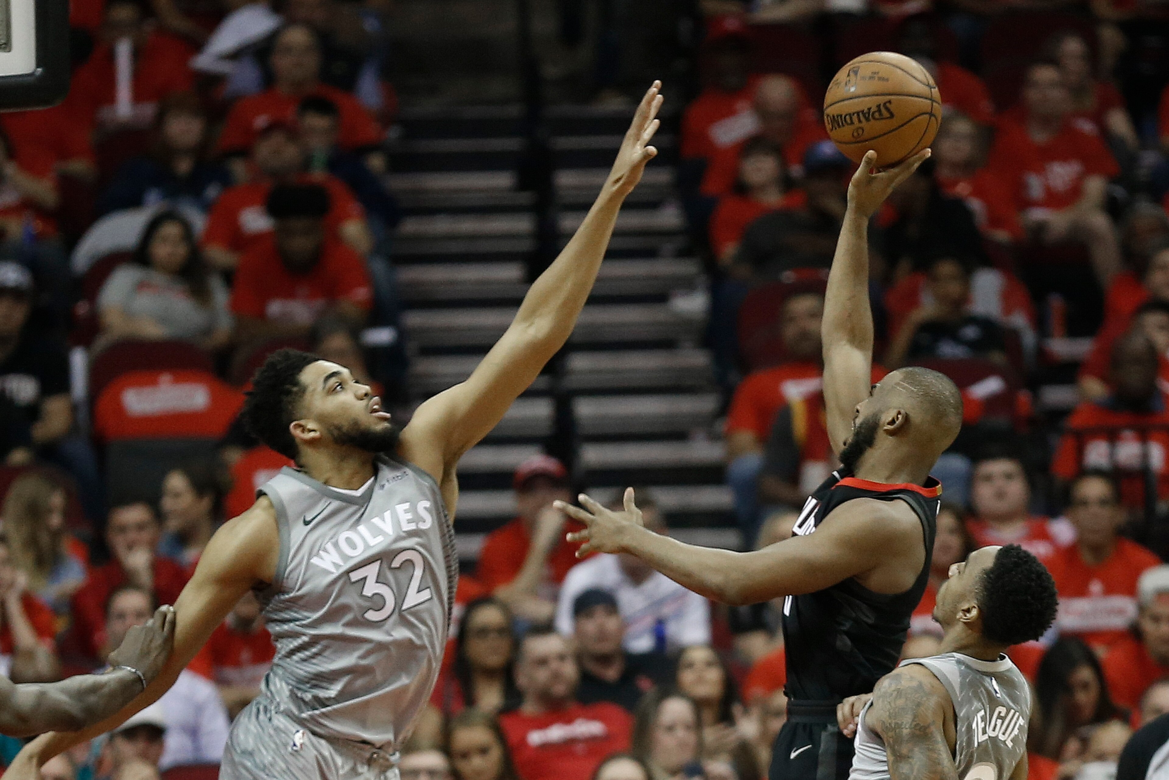 HOUSTON, TX - APRIL 18:  Chris Paul #3 of the Houston Rockets shoots over Karl-Anthony Towns #32 of the Minnesota Timberwolves in the third quarter during Game Two of the first round of the Western Conference playoffs at Toyota Center on April 18, 2018 in