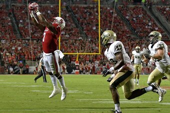 RALEIGH, NC - SEPTEMBER 01:  Nyheim Hines #7 of the North Carolina State Wolfpack makes a catch against Corey Parker #19 of the William & Mary Tribe during their game at Carter Finley Stadium on September 1, 2016 in Raleigh, North Carolina.  (Photo by Gra