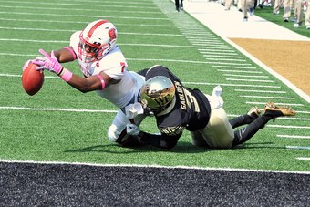 WINSTON-SALEM, NC - OCTOBER 24: Nyheim Hines #7 of the North Carolina State Wolfpack reaches for the goal line on a 58-yard touchdown pass against Devin Gaulden #3 of the Wake Forest Demon Deacons at BB&T Field on October 24, 2015 in Winston-Salem, North 