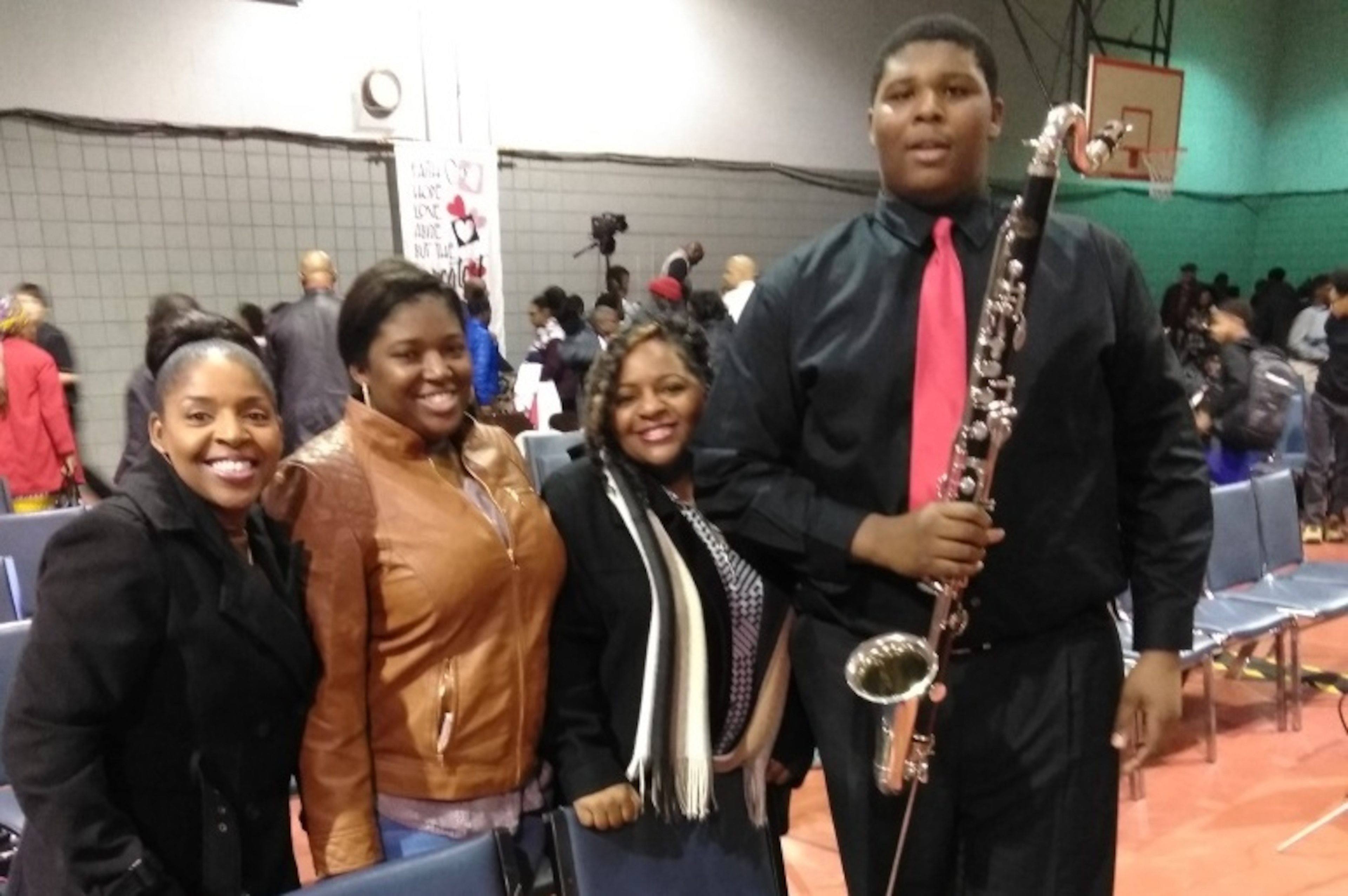 Kiyaunta Goodwin, pictured with his bass clarinet, with his family after a band concert. Kiyaunta Goodwin, pictured with his bass clarinet, with his family after a band concert.
