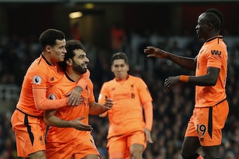 Liverpool's Egyptian midfielder Mohamed Salah (C) celebrates scoring the team's second goal with Liverpool's Brazilian midfielder Philippe Coutinho (L) and Liverpool's Senegalese midfielder Sadio Mane  during the English Premier League football match betw