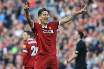 Liverpool's Brazilian midfielder Roberto Firmino celebrates after scoring their third goal during the English Premier League football match between Liverpool and Bournemouth at Anfield in Liverpool, north west England on April 14, 2018. / AFP PHOTO / Lind
