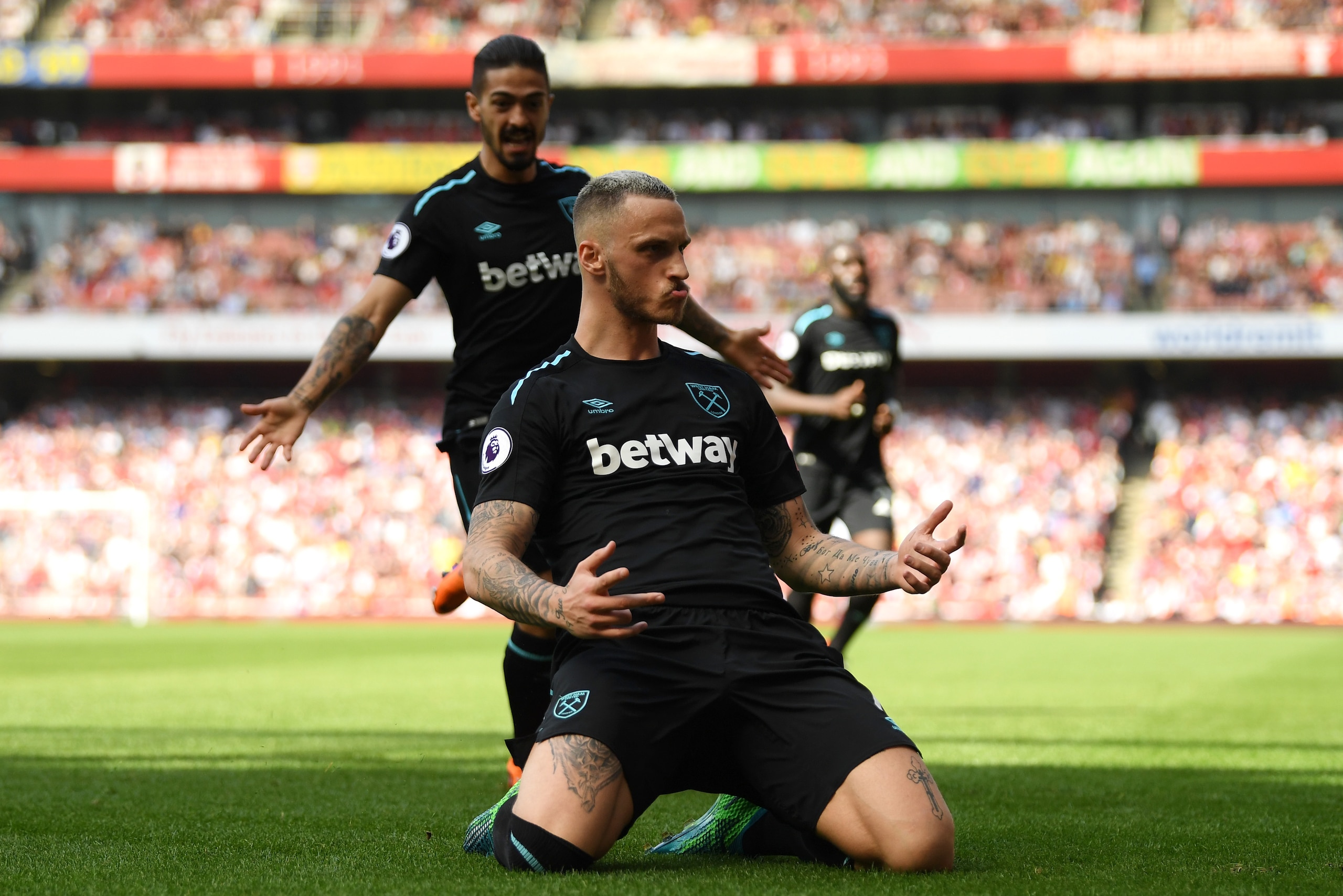 LONDON, ENGLAND - APRIL 22:  Marko Arnautovic of West Ham United celebrates scoring his side's first goal with Manuel Lanzini during the Premier League match between Arsenal and West Ham United at Emirates Stadium on April 22, 2018 in London, England.  (P