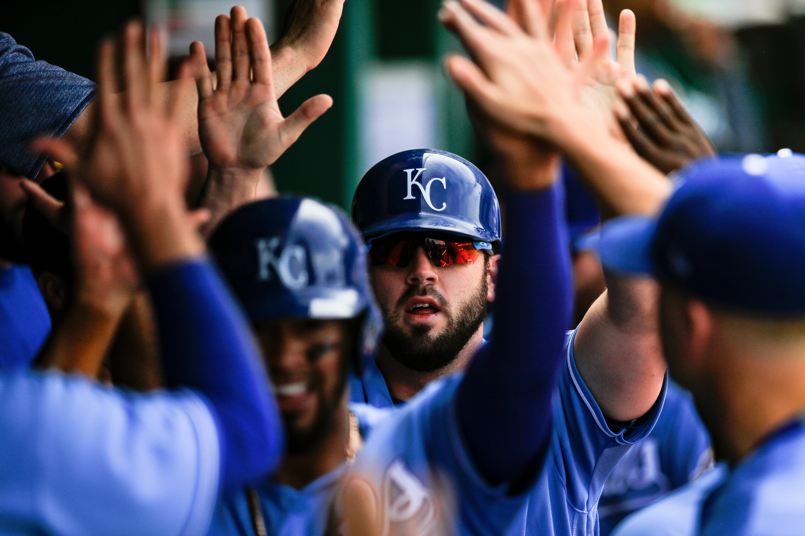 KANSAS CITY, MO - APRIL 11: Mike Moustakas #8 of the Kansas City Royals celebrates in the dugout after scoring a run in the fourth inning against the Seattle Mariners at Kauffman Stadium on April 11, 2018 in Kansas City, Missouri. (Photo by Brian Davidson