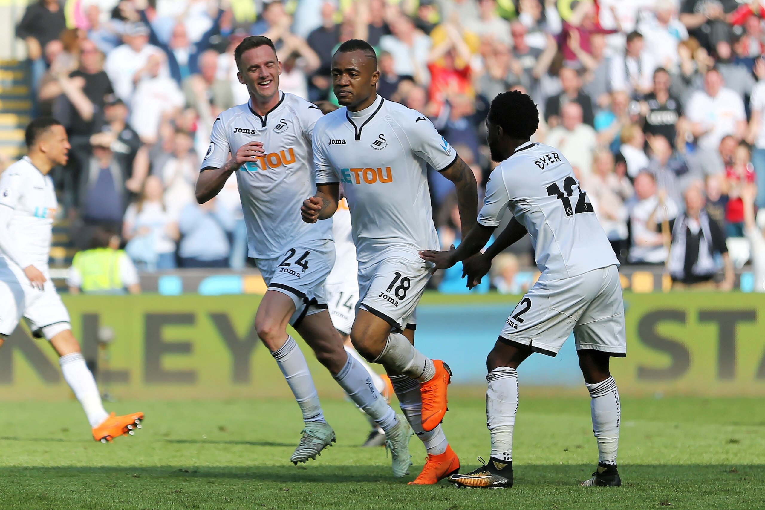 SWANSEA, WALES - APRIL 14: Jordan Ayew of Swansea City (C) celebrates his goal with team mates Andy King of (L) and Nathan Dyer (R) during the Premier League match between Swansea City and Everton at The Liberty Stadium on April 14, 2018 in Swansea, Wales SWANSEA, WALES - APRIL 14: Jordan Ayew of Swansea City (C) celebrates his goal with team mates Andy King of (L) and Nathan Dyer (R) during the Premier League match between Swansea City and Everton at The Liberty Stadium on April 14, 2018 in Swansea, Wales