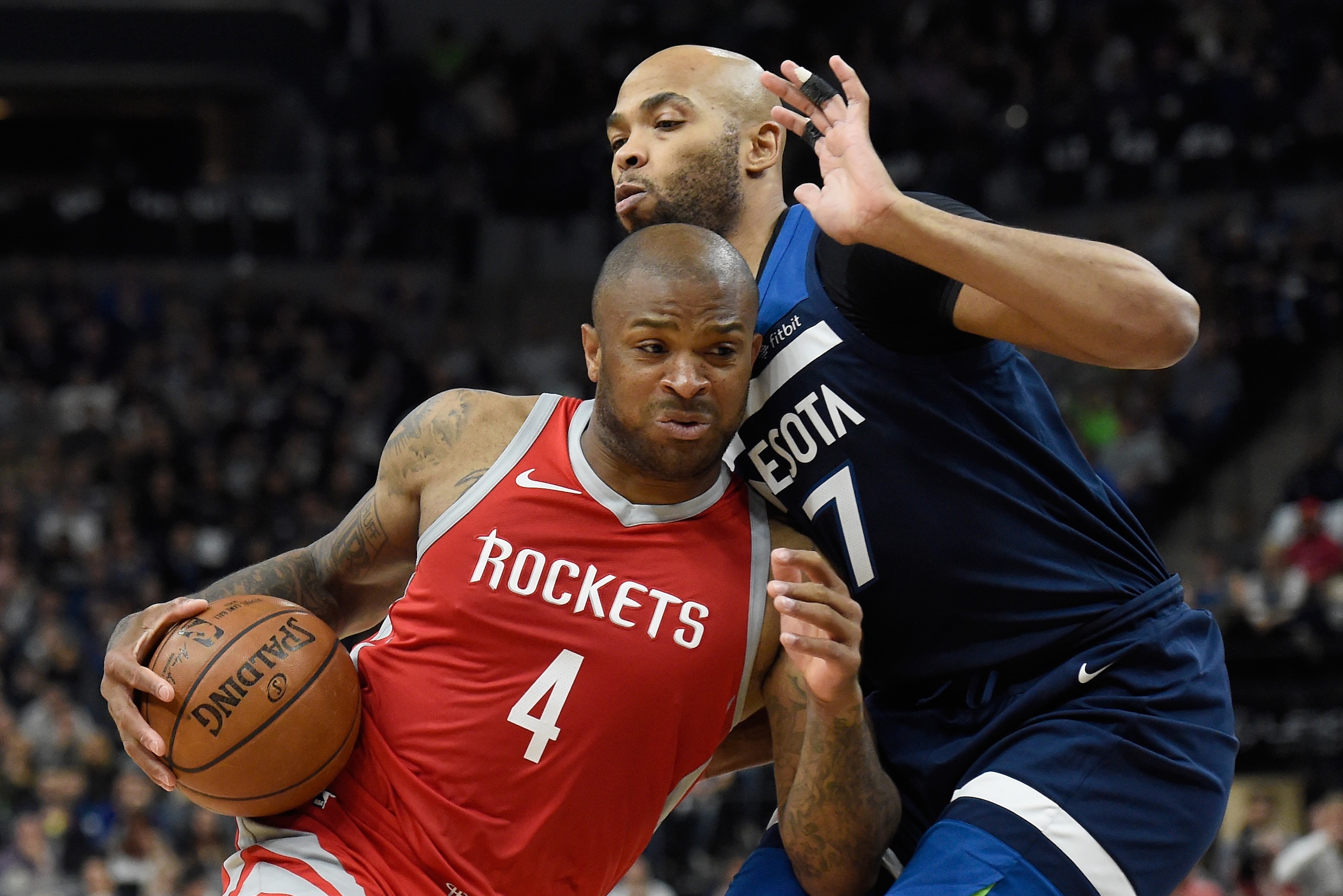 MINNEAPOLIS, MN - APRIL 21: PJ Tucker #4 of the Houston Rockets drives to the basket against Taj Gibson #67 of the Minnesota Timberwolves during the first quarter in Game Three of Round One of the 2018 NBA Playoffs on April 21, 2018 at the Target Center i