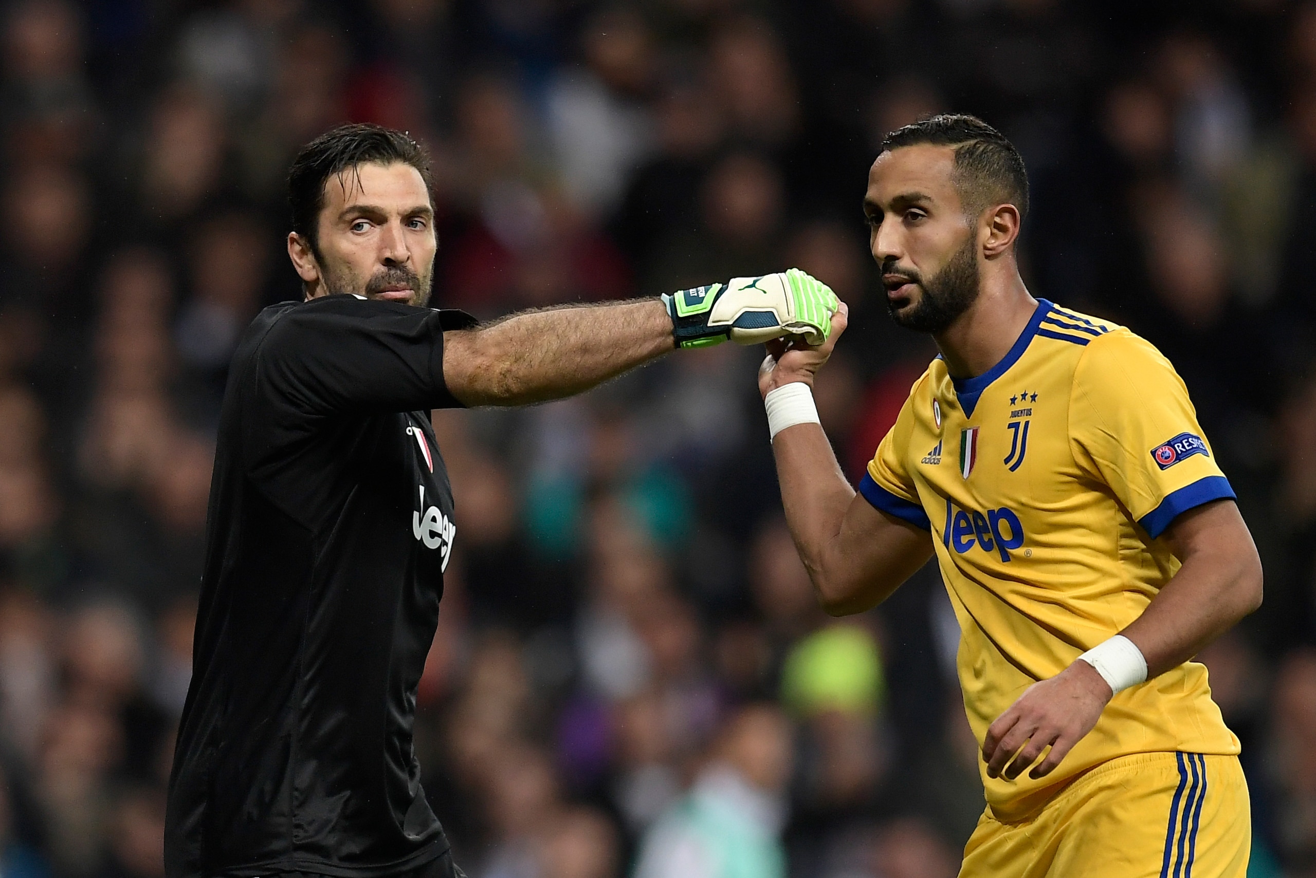 Juventus' Italian goalkeeper Gianluigi Buffon (L) celebrates with Juventus' Italian defender Medhi Benatia during the UEFA Champions League quarter-final second leg football match between Real Madrid CF and Juventus FC at the Santiago Bernabeu stadium in 