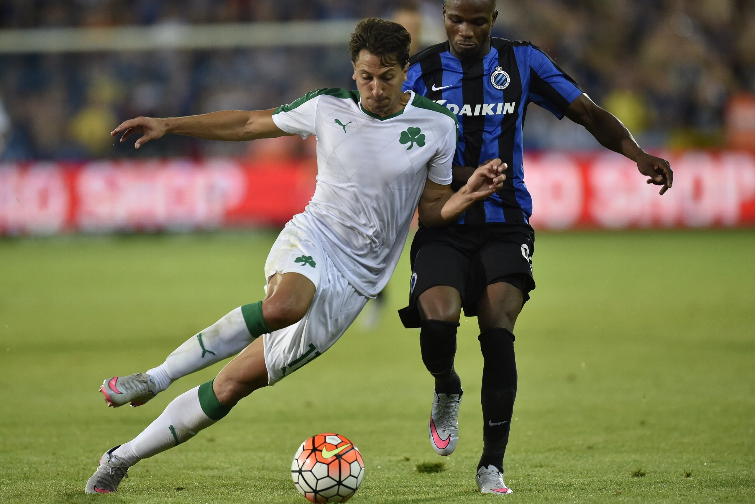 Club Bruggess Bolingoli Mbombo (R) vies for the ball with  Panathinaikos Jens Wemmer (R) during the UEFA Champions League third round qualifying football match between Club Brugge and Panathinaikos at Jan Breydel stadium in Bruges on August 5, 2015. AFP P
