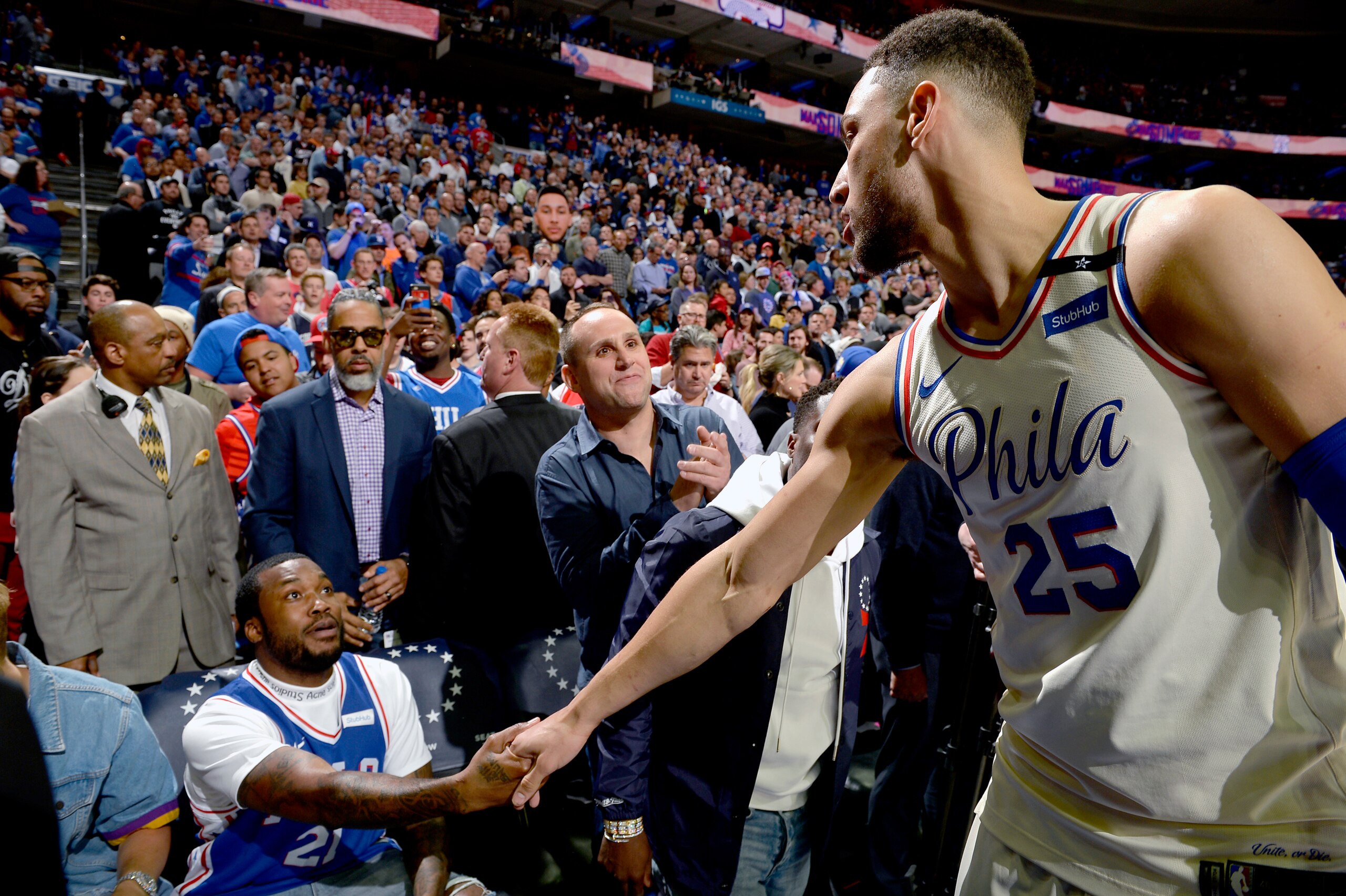 PHILADELPHIA, PA - APRIL 24:  Meek Mill and Ben Simmons #25 of the Philadelphia 76ers high five before the game against the Miami Heat in Game Five of Round One of the 2018 NBA Playoffs on April 24, 2018 at the Wells Fargo Center in Philadelphia, Pennsylv