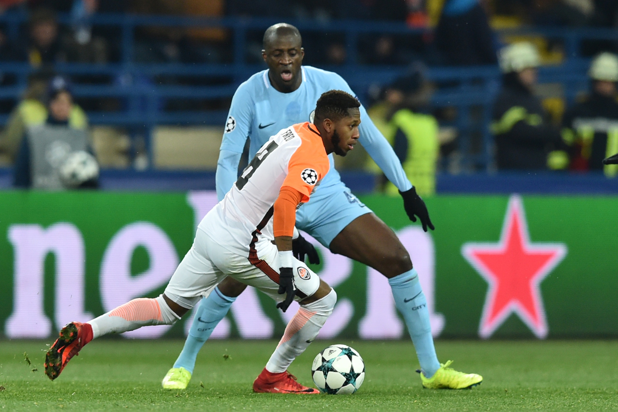 Shakhtar Donetsk's Brazilian midfielder Fred (white jersey) drives the ball next to Manchester City's Ivorian midfielder Yaya Toure during the UEFA Champions League group F football match between Shakhtar Donetsk and Manchester City, on December 6, 2017, 