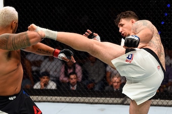 BRISBANE, AUSTRALIA - MARCH 20:  (R-L) Frank Mir of the United States kicks Mark Hunt of New Zealand in their heavyweight bout during the UFC Fight Night event at the Brisbane Entertainment Centre on March 20, 2016 in Brisbane, Australia. (Photo by Josh H