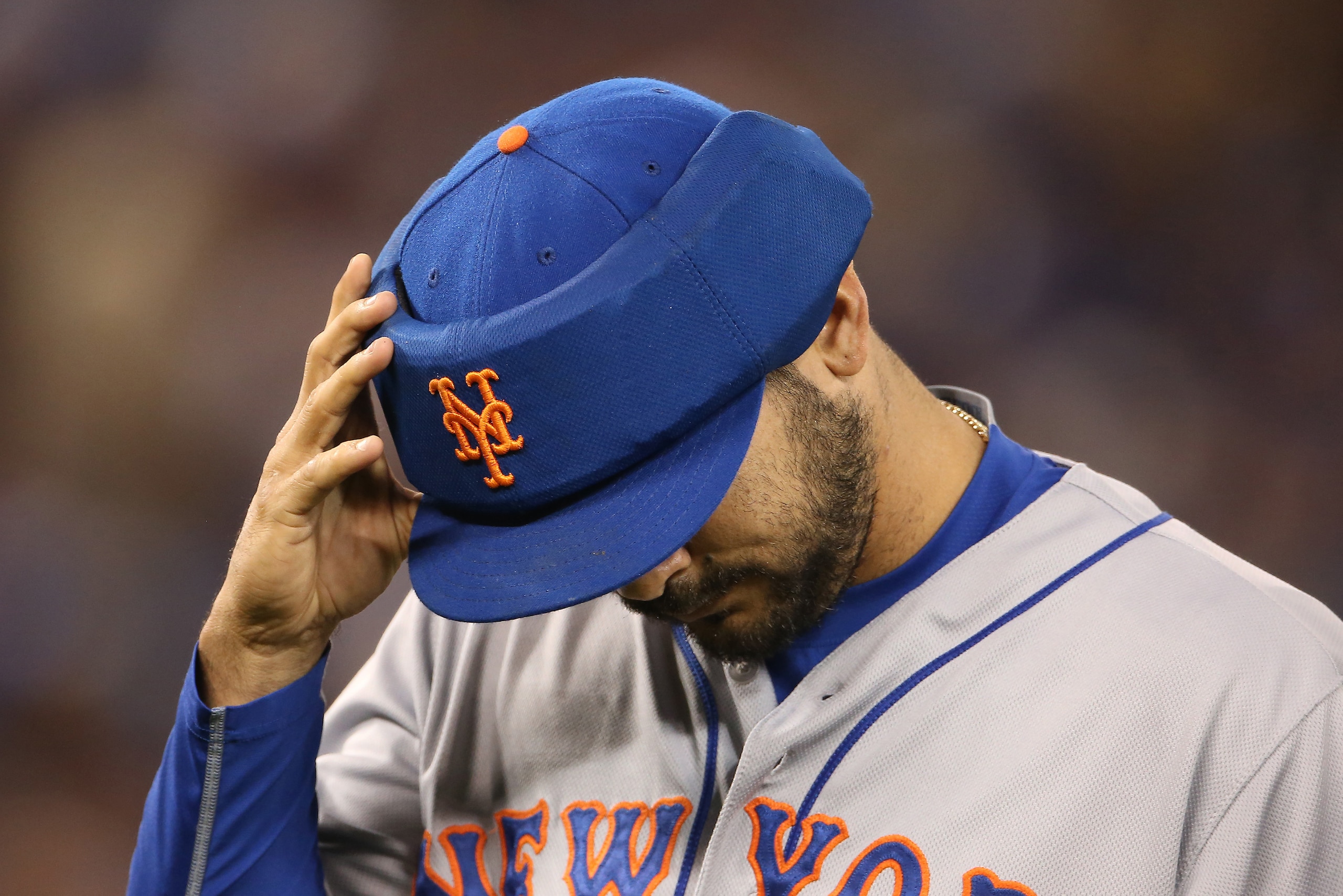 TORONTO, CANADA - JUNE 18: Alex Torres #54 of the New York Mets reaches for his protective cap as he walks off the mound at the end of the fifth inning during MLB game action against the Toronto Blue Jays on June 18, 2015 at Rogers Centre in Toronto, Onta TORONTO, CANADA - JUNE 18: Alex Torres #54 of the New York Mets reaches for his protective cap as he walks off the mound at the end of the fifth inning during MLB game action against the Toronto Blue Jays on June 18, 2015 at Rogers Centre in Toronto, Onta