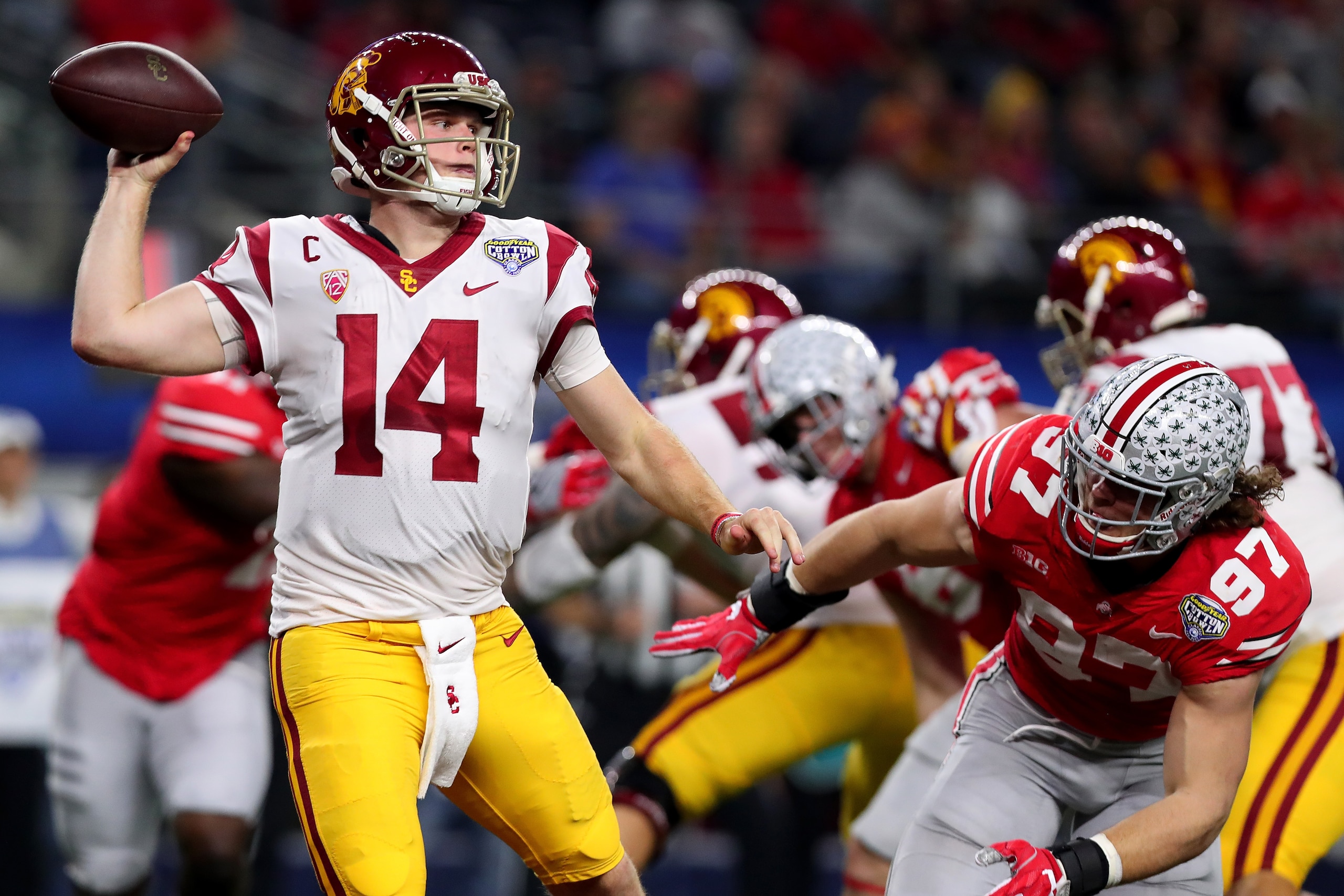 ARLINGTON, TX - DECEMBER 29:  Sam Darnold #14 of the USC Trojans looks for an open receiver against Nick Bosa #97 of the Ohio State Buckeyes during the Goodyear Cotton Bowl Classic at AT&T Stadium on December 29, 2017 in Arlington, Texas.  (Photo by Tom P