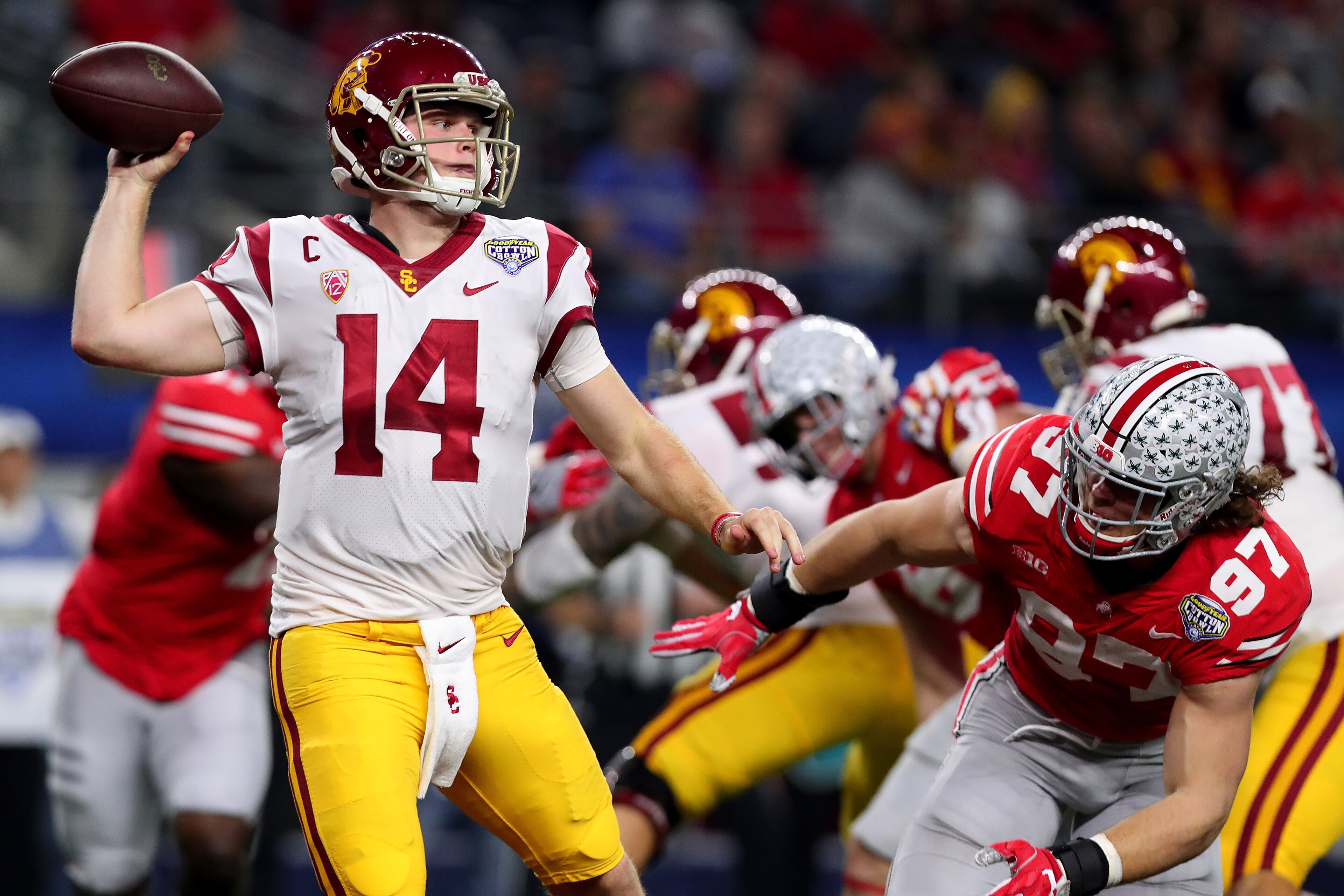ARLINGTON, TX - DECEMBER 29:  Sam Darnold #14 of the USC Trojans looks for an open receiver against Nick Bosa #97 of the Ohio State Buckeyes during the Goodyear Cotton Bowl Classic at AT&T Stadium on December 29, 2017 in Arlington, Texas.  (Photo by Tom P