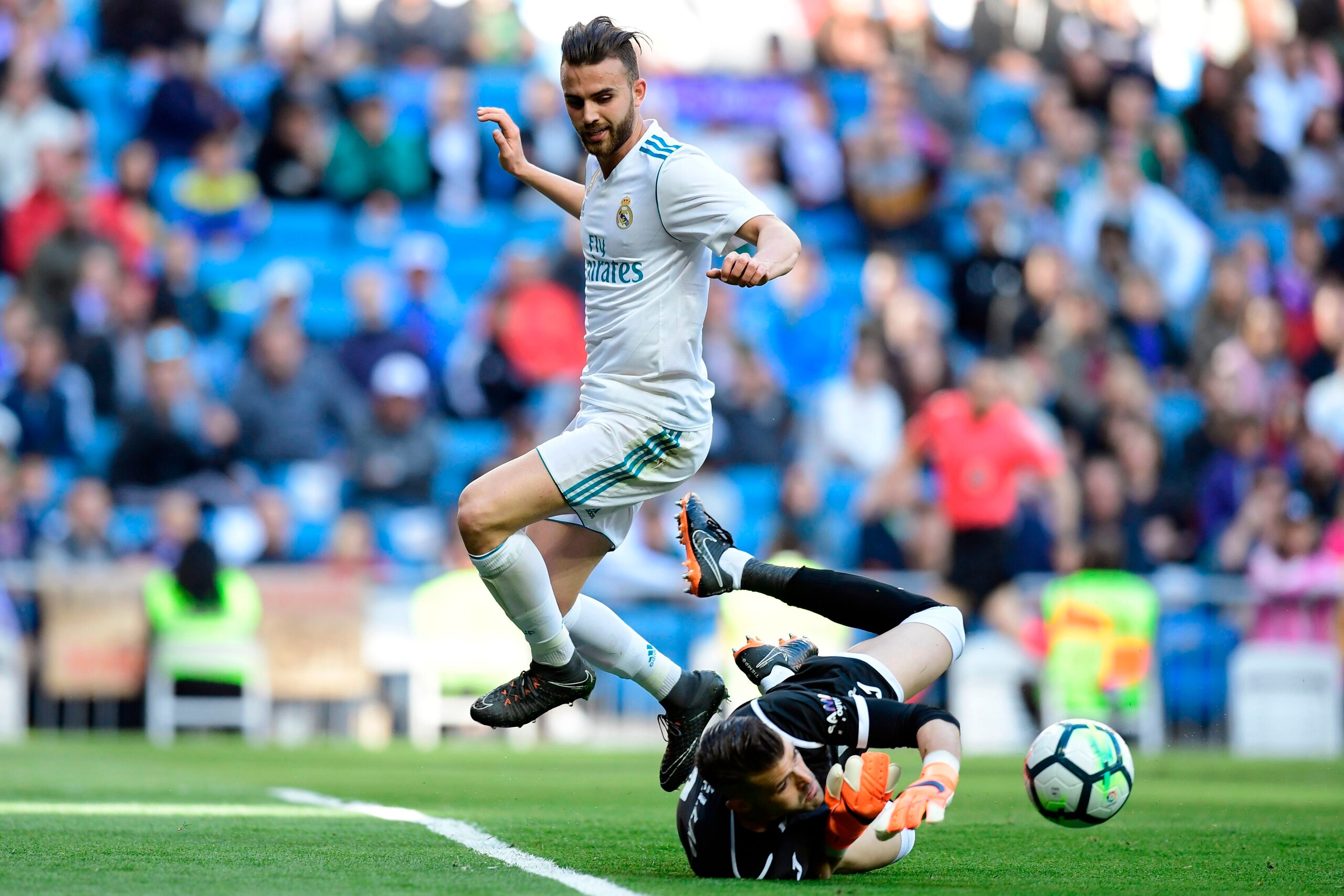 Leganes' Spanish goalkeeper Pichu Cuellar blocks a shot on goal by Real Madrid's Spanish forward Borja Mayoral (L) during the Spanish League football match between Real Madrid and Leganes at the Santiago Bernabeu Stadium in Madrid on April 28, 2018. (Phot