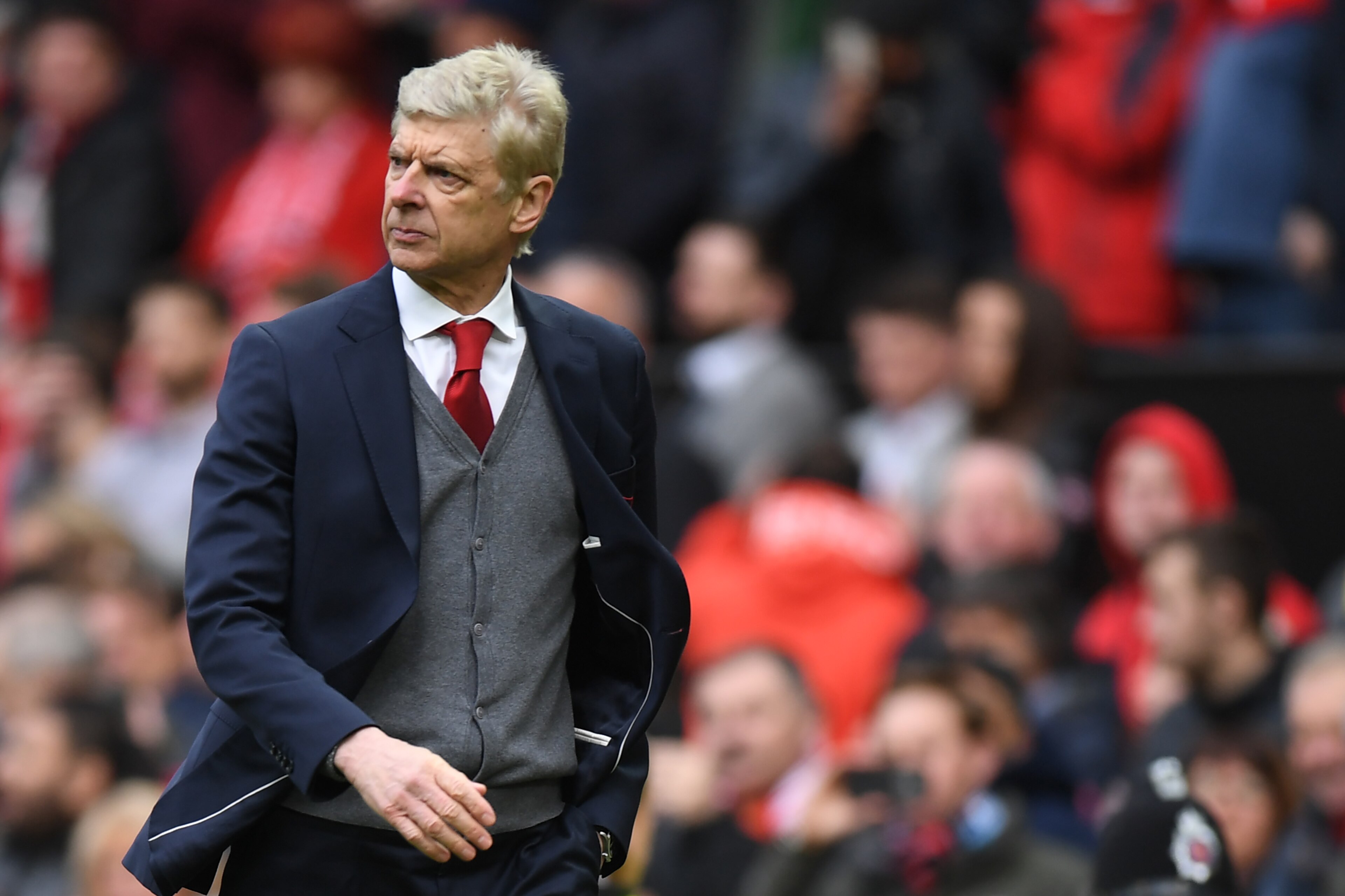 Arsenal's French manager Arsene Wenger leaves the pitch after the English Premier League football match between Manchester United and Arsenal at Old Trafford in Manchester, north west England, on April 29, 2018. - Manchester United won the game 2-1. (Phot