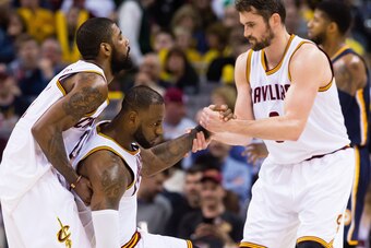 CLEVELAND, OH - APRIL 2: Kyrie Irving #2 and Kevin Love #0 of the Cleveland Cavaliers help LeBron James #23 of the Cleveland Cavaliers to his feet after James was fouled during the second half against the Indiana Pacers at Quicken Loans Arena on April 2, 